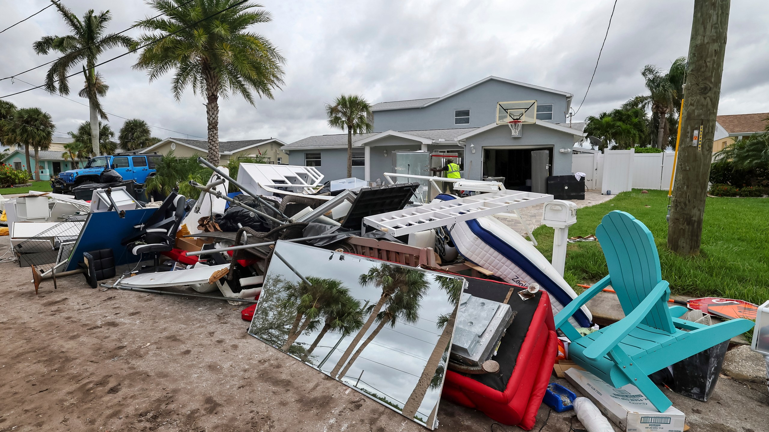 Contractors with the City of New Port Richey help clean debris left by Hurricane Helene in preparation for Hurricane Milton on Monday, Oct. 7, 2024, in New Port Richey, Fla. (AP Photo/Mike Carlson)