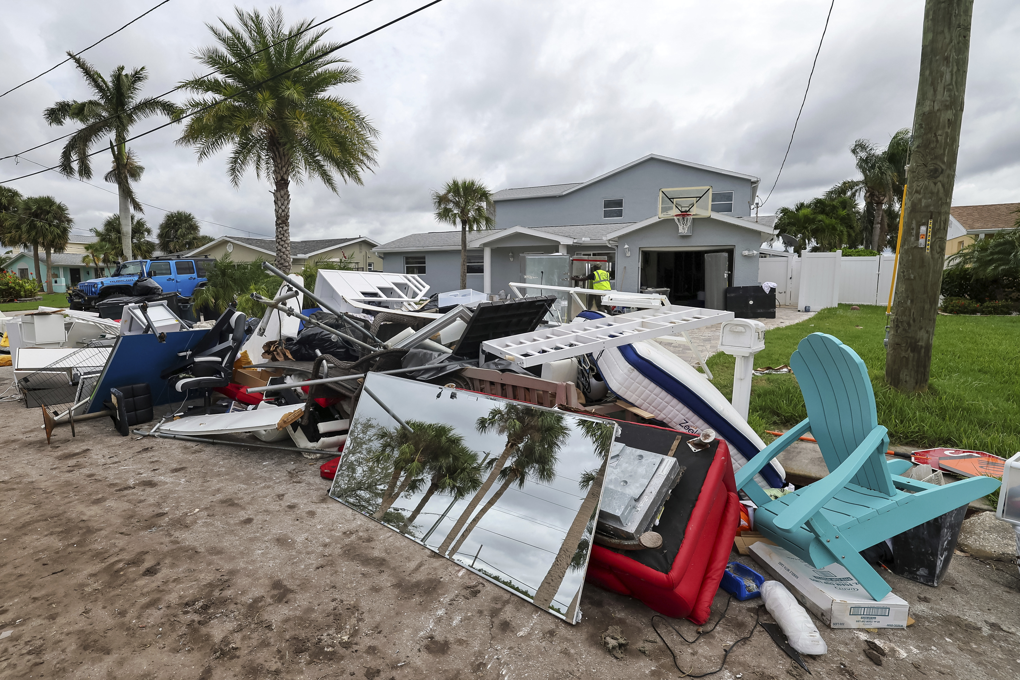 Contractors with the City of New Port Richey help clean debris left by Hurricane Helene in preparation for Hurricane Milton on Monday, Oct. 7, 2024, in New Port Richey, Fla. (AP Photo/Mike Carlson)