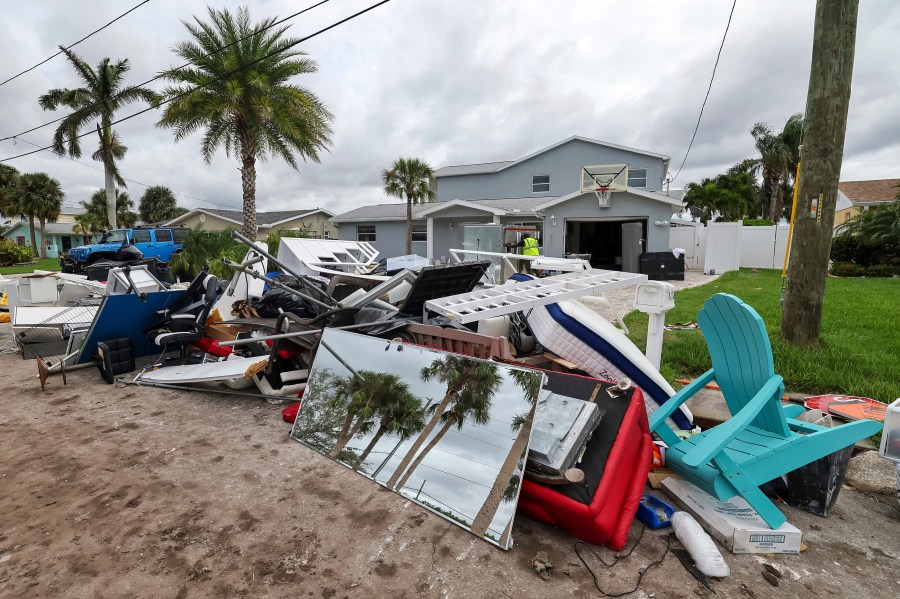 Contractors with the City of New Port Richey help clean debris left by Hurricane Helene in preparation for Hurricane Milton on Monday, Oct. 7, 2024, in New Port Richey, Fla. (AP Photo/Mike Carlson)