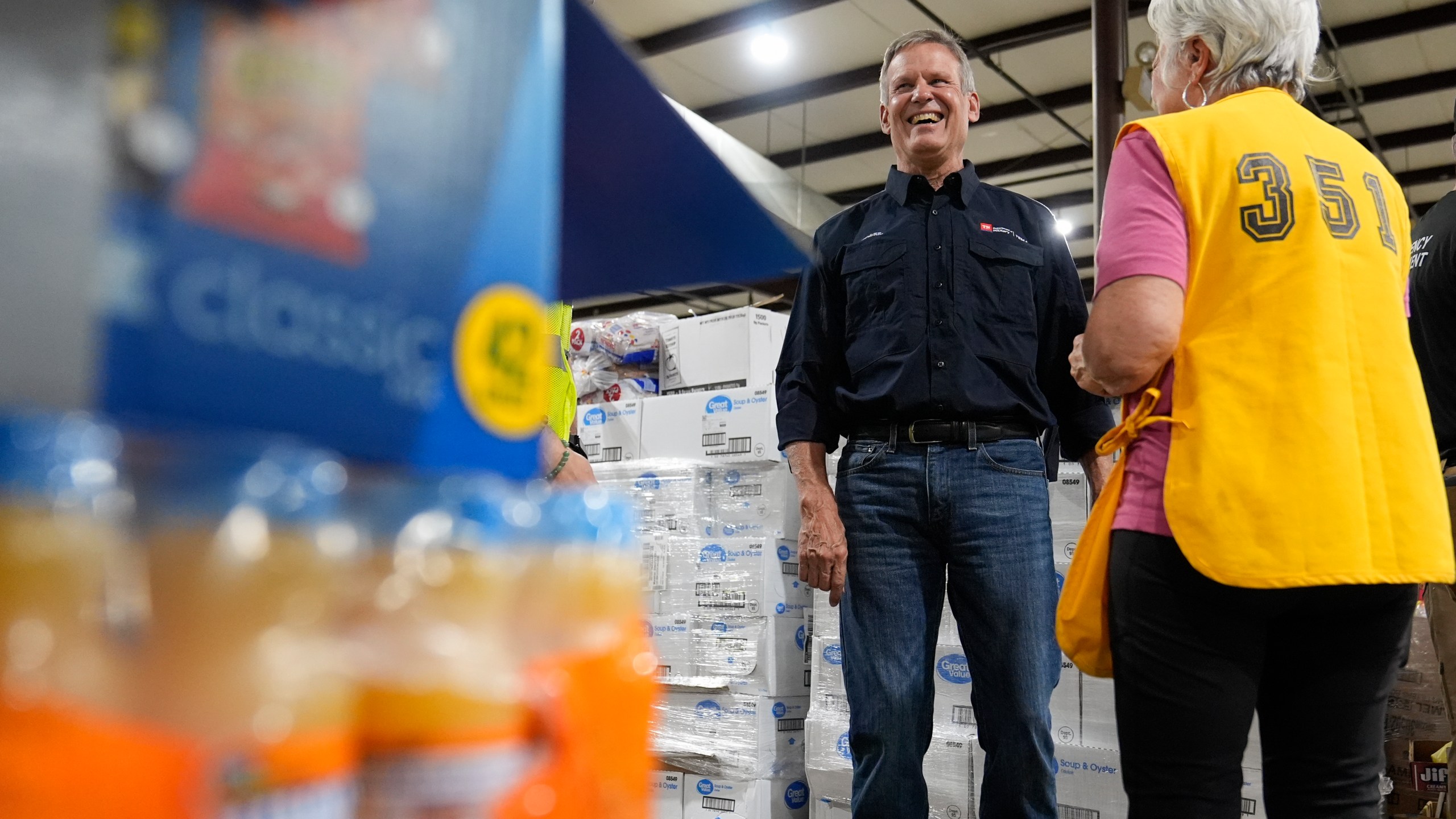 Tennessee Gov. Bill Lee visits with a volunteer at the East Tennessee Disaster Relief Center, for Hurricane Helene disaster response Monday, Oct. 7, 2024, in Bristol, Tenn. (AP Photo/George Walker IV via Pool)