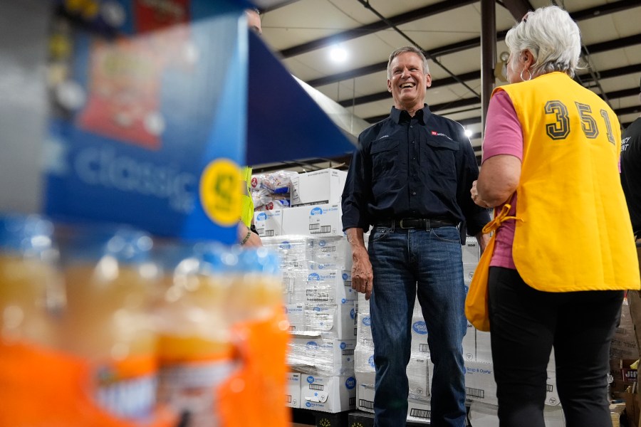 Tennessee Gov. Bill Lee visits with a volunteer at the East Tennessee Disaster Relief Center, for Hurricane Helene disaster response Monday, Oct. 7, 2024, in Bristol, Tenn. (AP Photo/George Walker IV via Pool)