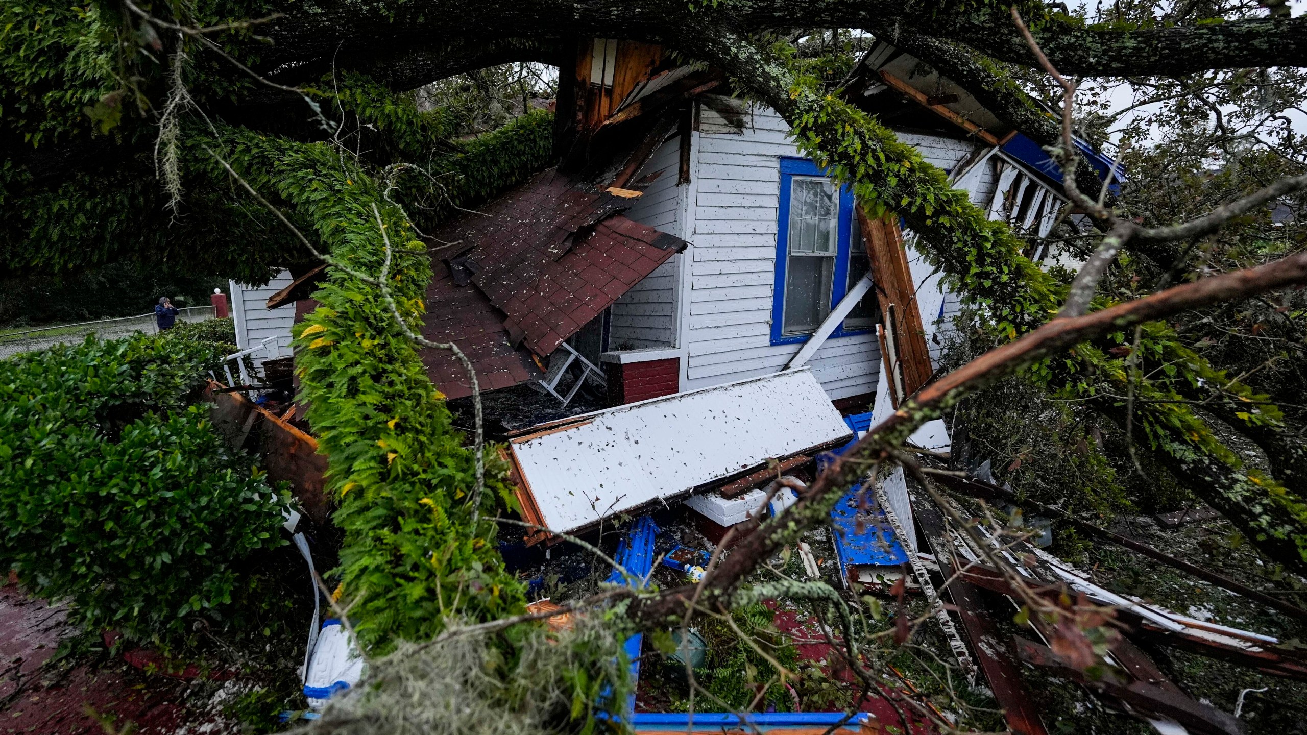 FILE - A damaged 100-year-old home is seen after an Oak tree landed on it after Hurricane Helene moved through the area, Sept. 27, 2024, in Valdosta, Ga. (AP Photo/Mike Stewart, File)