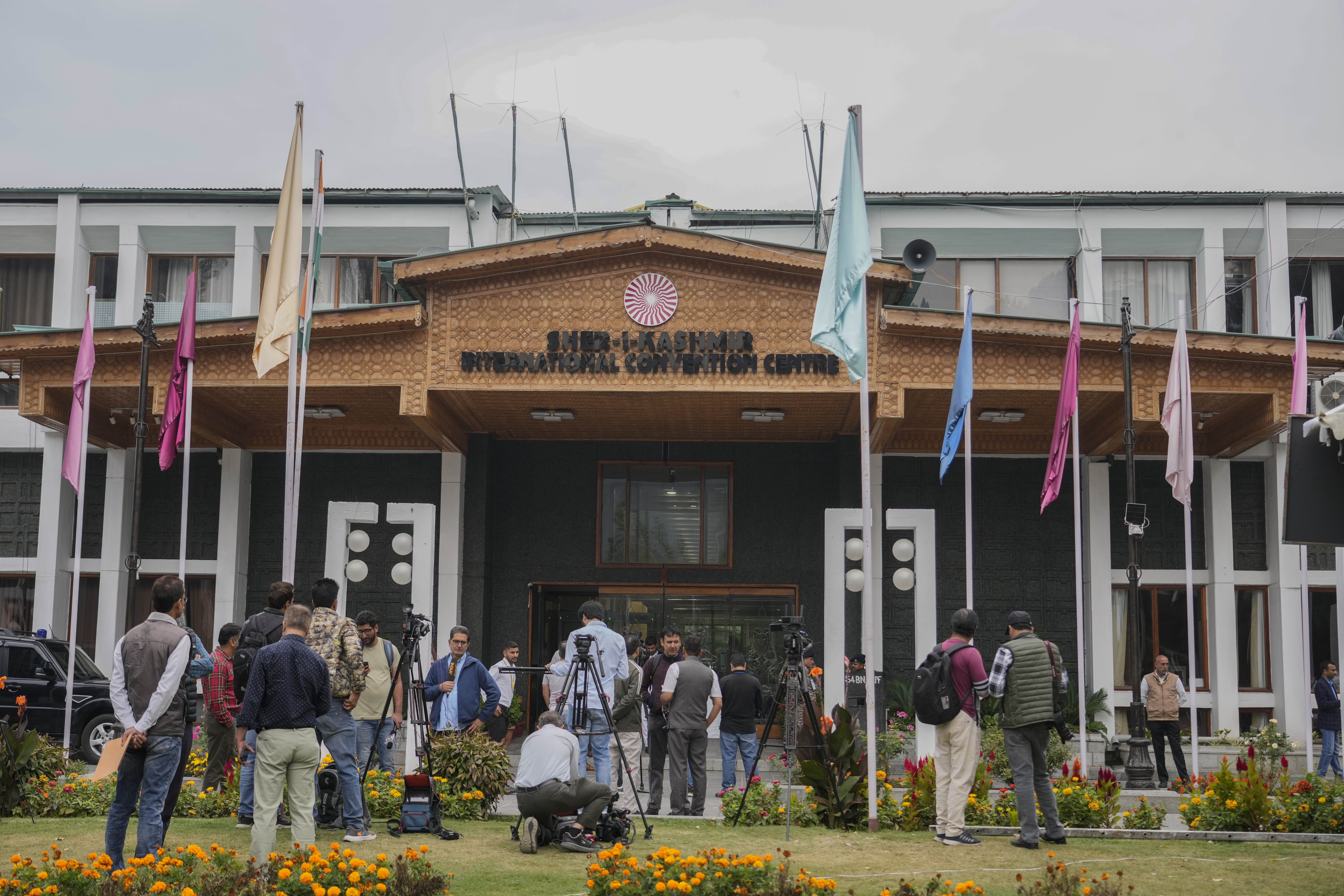 Media persons wait outside a vote counting center the recent election on the outskirts of Srinagar, Indian controlled Kashmir, Tuesday, Oct. 8, 2024. (AP Photo/Mukhtar Khan)