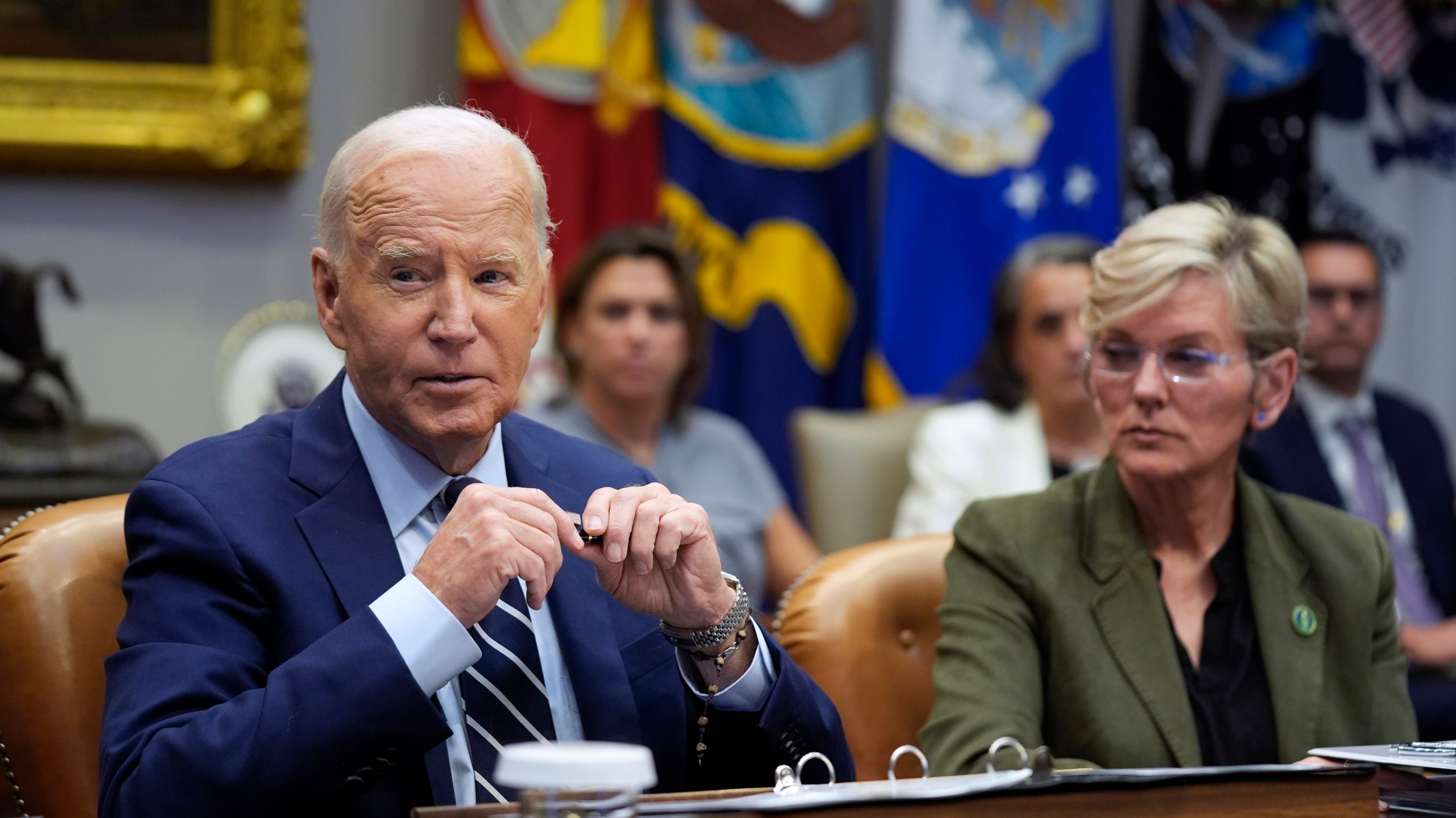 President Joe Biden delivers remarks on the federal government's response to Hurricane Helene and preparations for Hurricane Milton in the Roosevelt Room of the White House, Tuesday, Oct. 8, 2024, in Washington, as Secretary of Energy Jennifer Granholm looks on. (AP Photo/Evan Vucci)