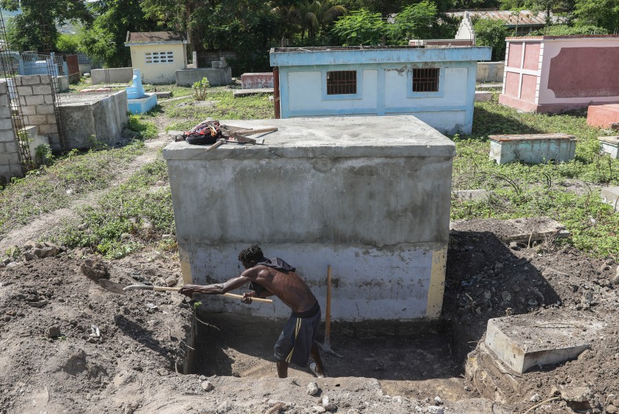 A cemetery worker prepares a grave days after a deadly gang attack on Pont-Sonde, Haiti, Tuesday, Oct. 8, 2024. (AP Photo/Odelyn Joseph)