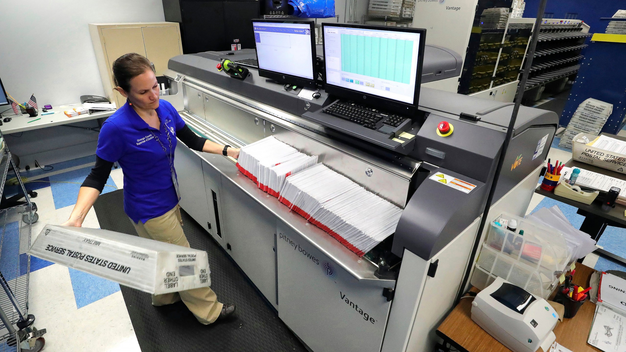 FILE - A worker processes mail-in ballots for the state's primary elections at the Orange County Supervisor of Elections office in Orlando, Fla., March 17, 2020. (Joe Burbank/Orlando Sentinel via AP, File)