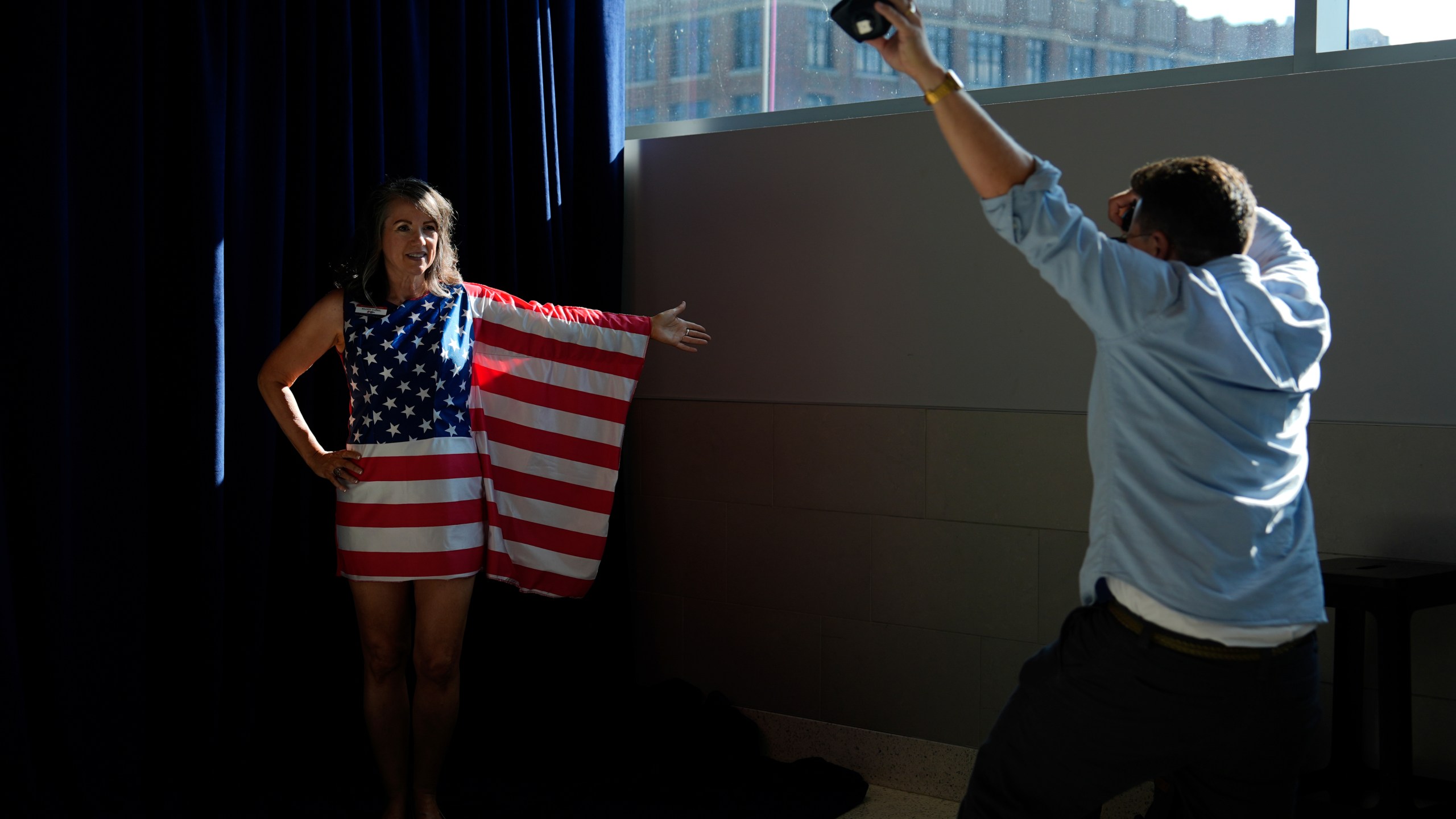 FILE - A person in American flag poses for pictures during the Republican National Convention Thursday, July 18, 2024, in Milwaukee. (AP Photo/Julia Nikhinson, File)