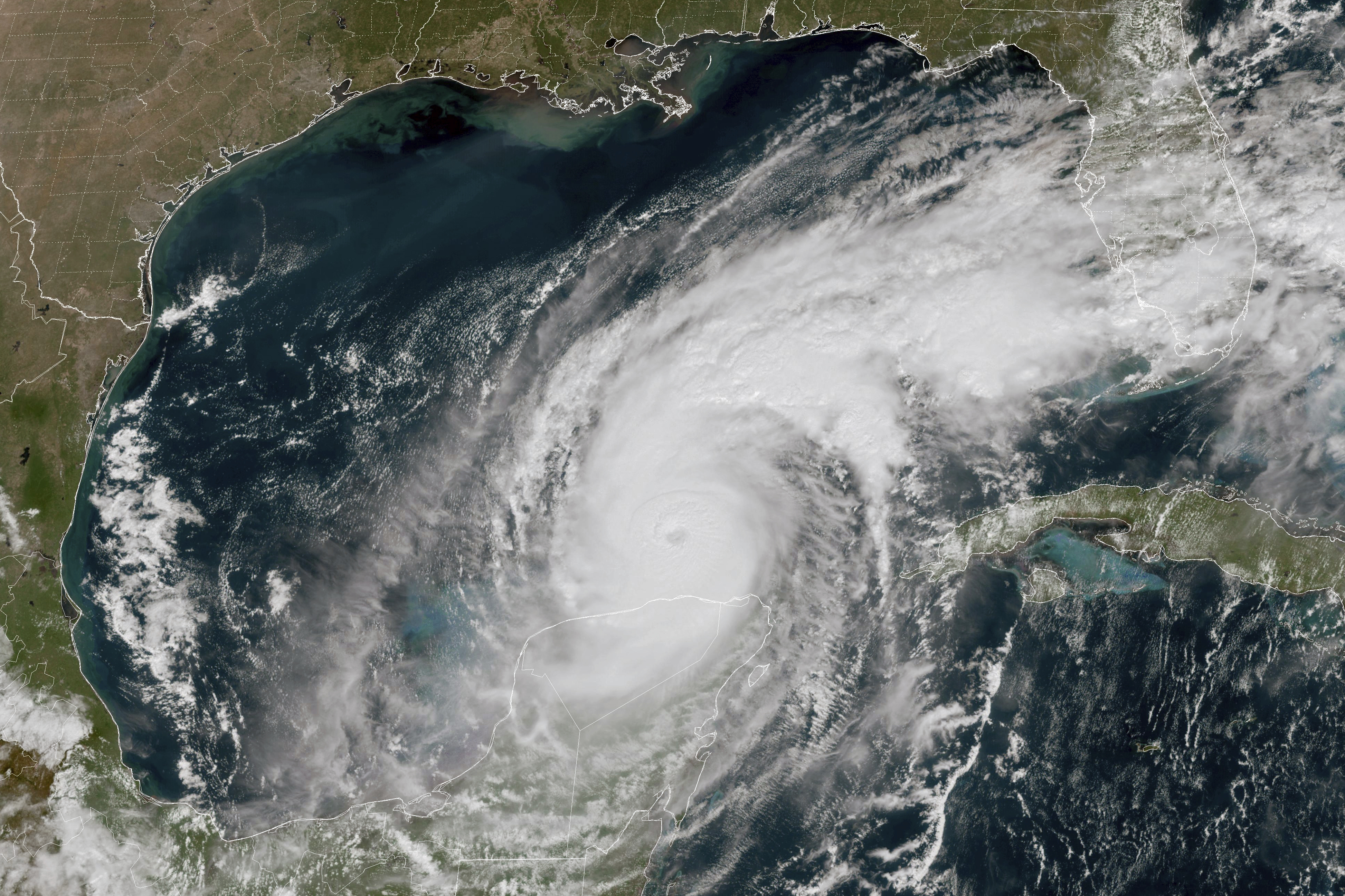 This GOES-16 GeoColor satellite image taken at 12:15 p.m. EDT and provided by National Oceanic and Atmospheric Administration (NOAA) shows Hurricane Milton in the Gulf of Mexico, off the coast off Mexico’s Yucatan Peninsula Tuesday, Oct. 8, 2024. (NOAA via AP)