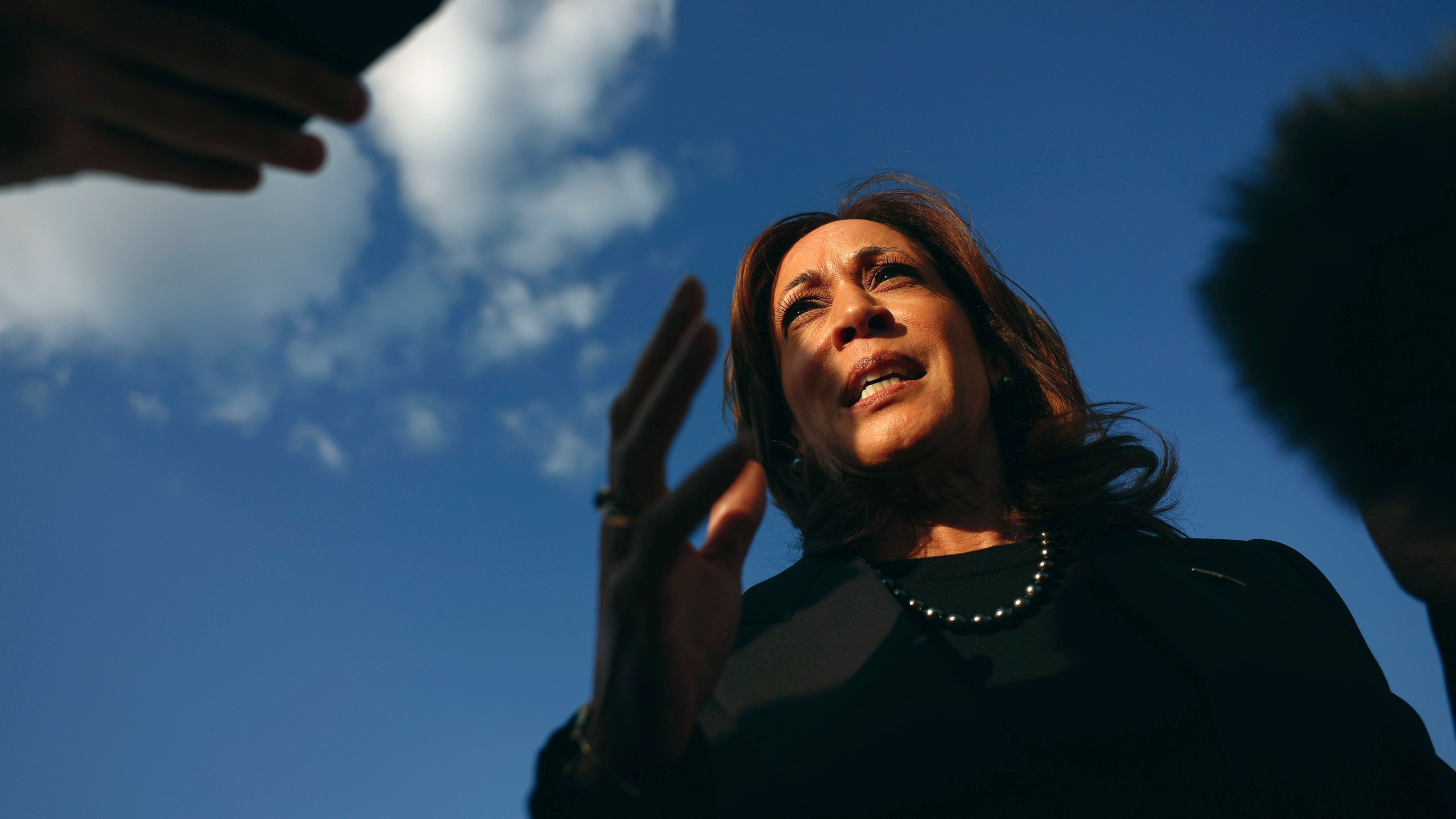 Democratic presidential nominee Vice President Kamala Harris speaks to reporters before boarding Air Force Two to depart for New York at Joint Base Andrews, Md., Monday, Oct. 7, 2024. (Evelyn Hockstein/Pool via AP)