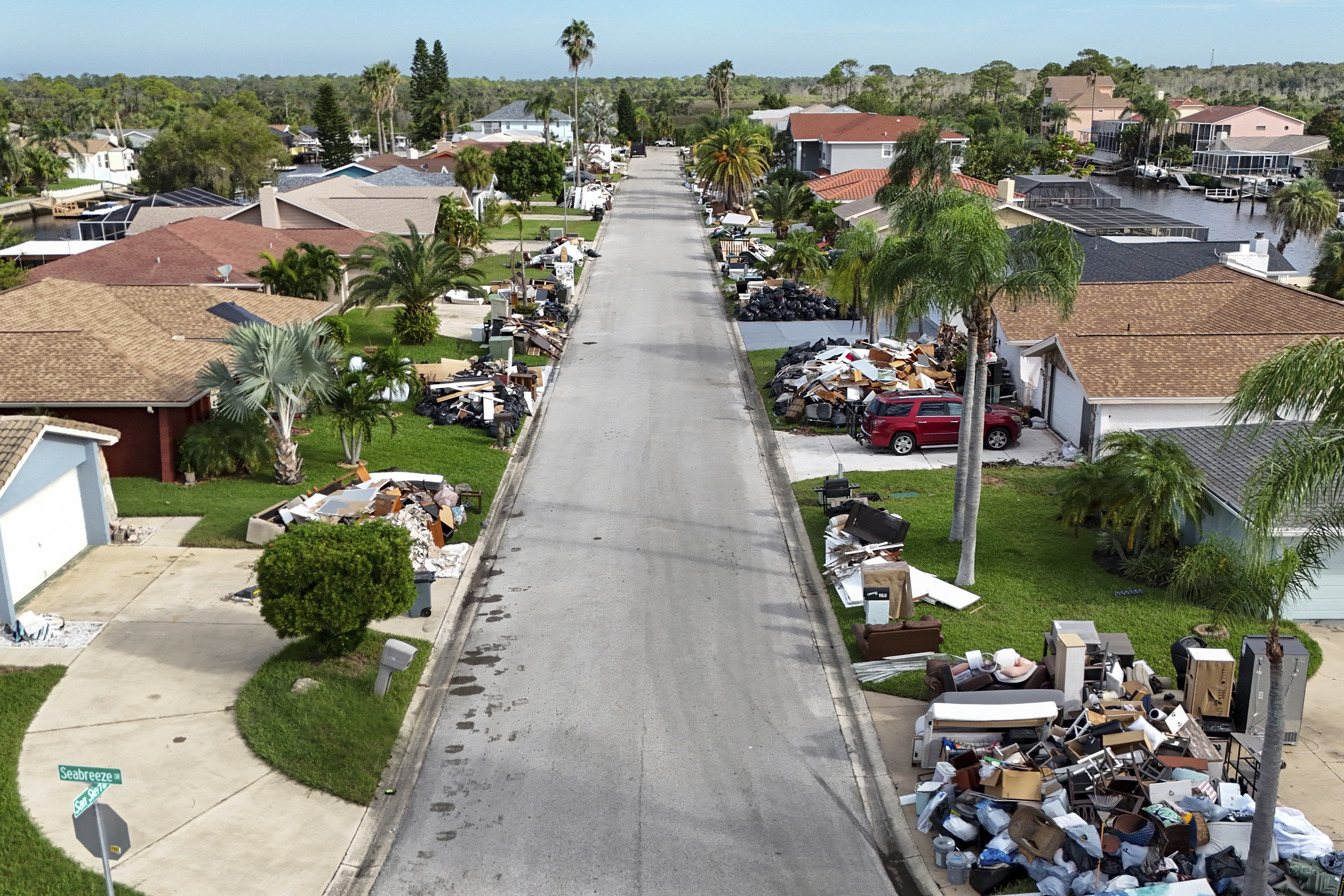 Debris from homes flooded in Hurricane Helene sits curbside as Hurricane Milton approaches on Tuesday, Oct. 8, 2024, in Port Richey, Fla. (AP Photo/Mike Carlson)