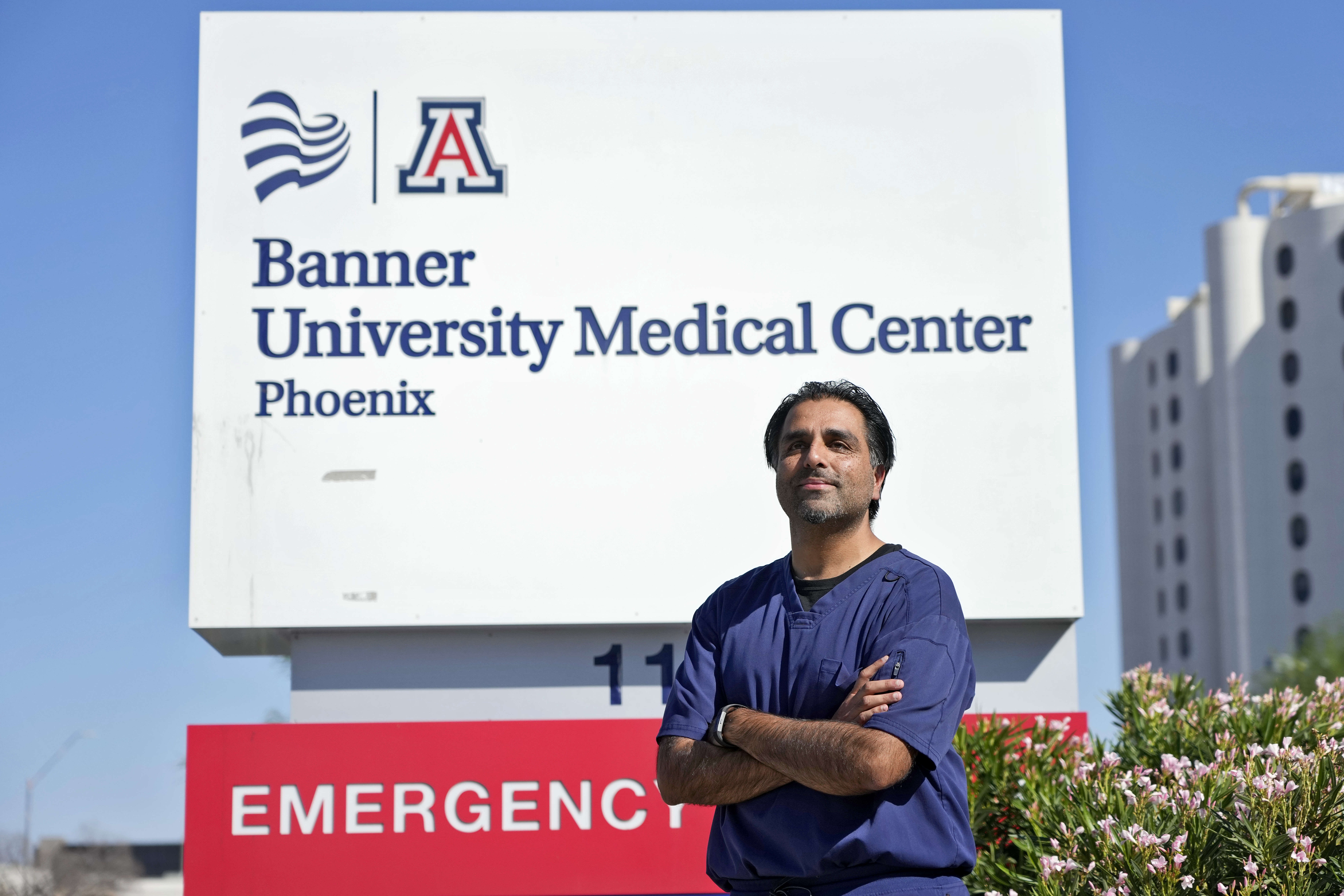 Dr. Aneesh Naran stands outside the Banner University Medical Center emergency room after his shift, Monday, Oct. 7, 2024 in Phoenix. (AP Photo/Matt York)