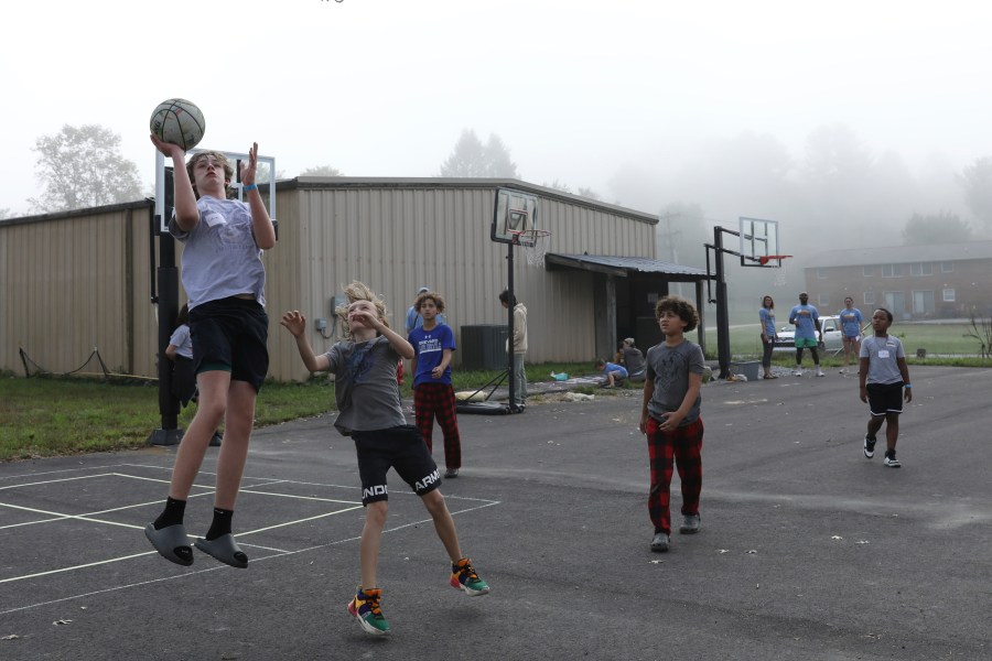 Boys play basketball at the Project:Camp pop-up daycamp for families impacted by Hurricane Helene in Brevard, N.C., Monday, Oct. 7, 2024. (AP Photo/Gabriela Aoun Angueira)