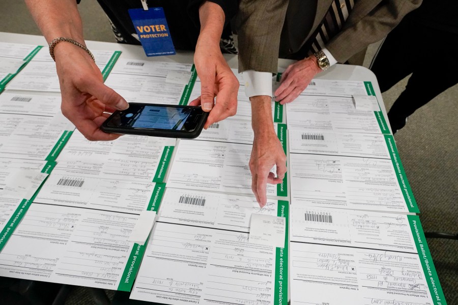 FILE - A canvas observer photographs Lehigh County provisional ballots as vote counting in the general election continues, Nov. 6, 2020, in Allentown, Pa. (AP Photo/Mary Altaffer, File)