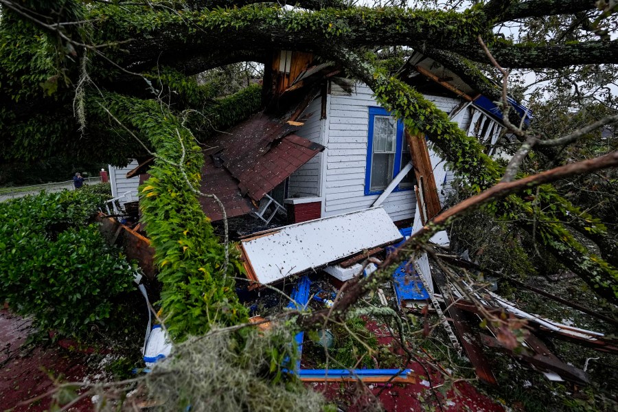 FILE - A damaged 100-year-old home is seen after an Oak tree landed on it after Hurricane Helene moved through the area, Sept. 27, 2024, in Valdosta, Ga. (AP Photo/Mike Stewart, File)