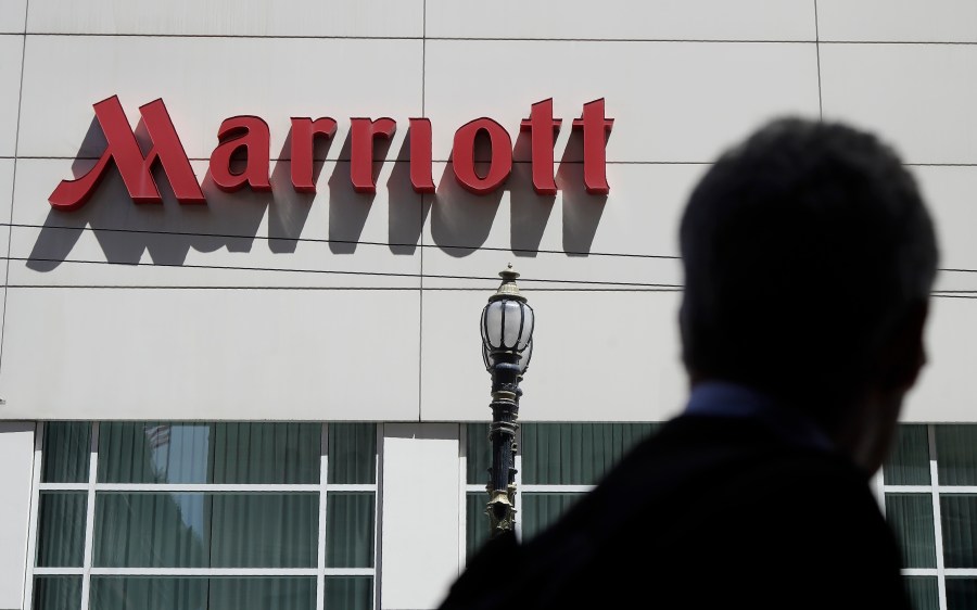 FILE - A person walks past the San Francisco Marriott Union Square hotel on July 11, 2019, in San Francisco. (AP Photo/Jeff Chiu, File)