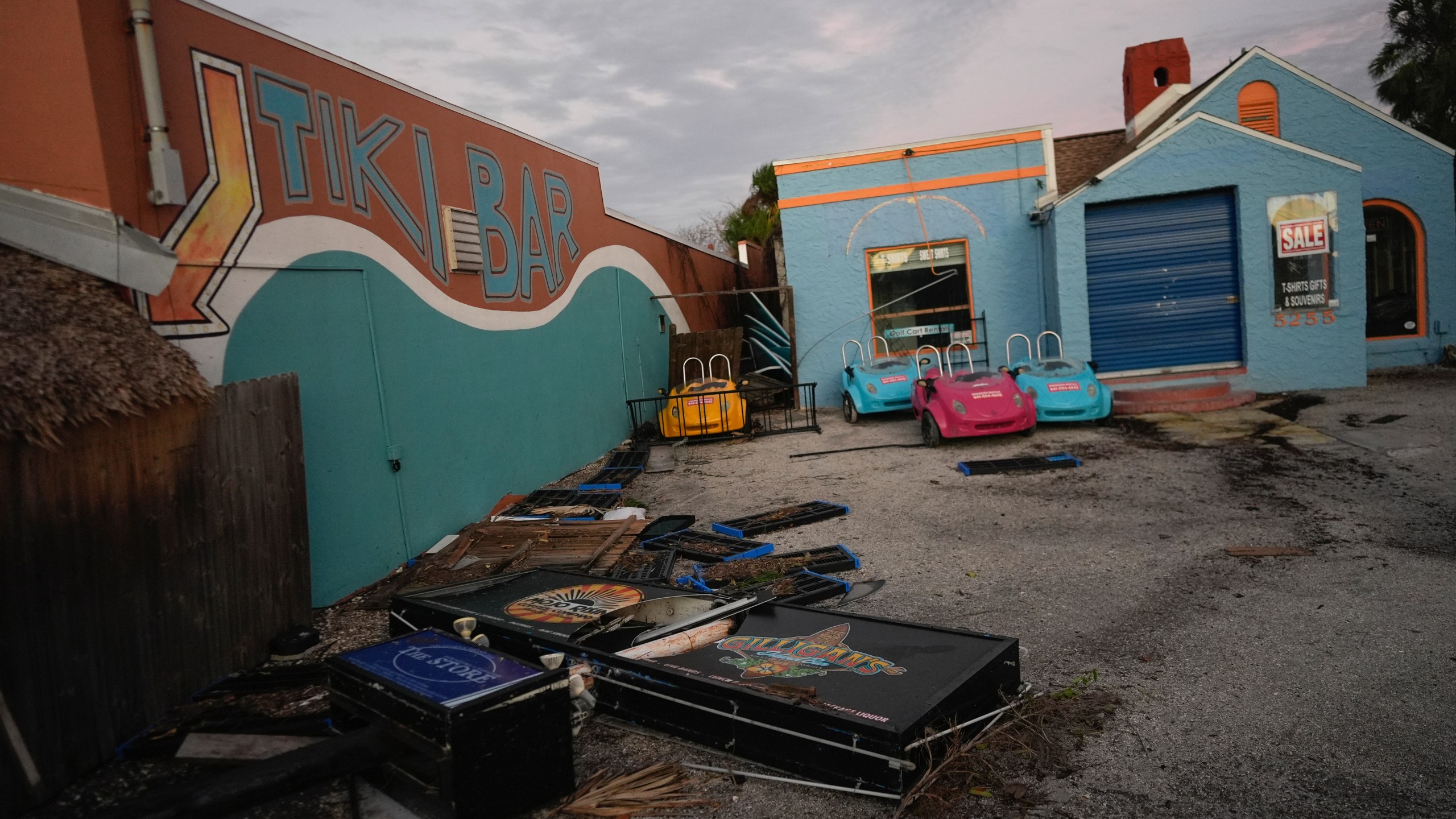 A broken sign and other debris lie alongside Gilligan's Island Bar & Grill after the passage of Hurricane Milton, in Siesta Key, Fla., Thursday, Oct. 10, 2024. (AP Photo/Rebecca Blackwell)