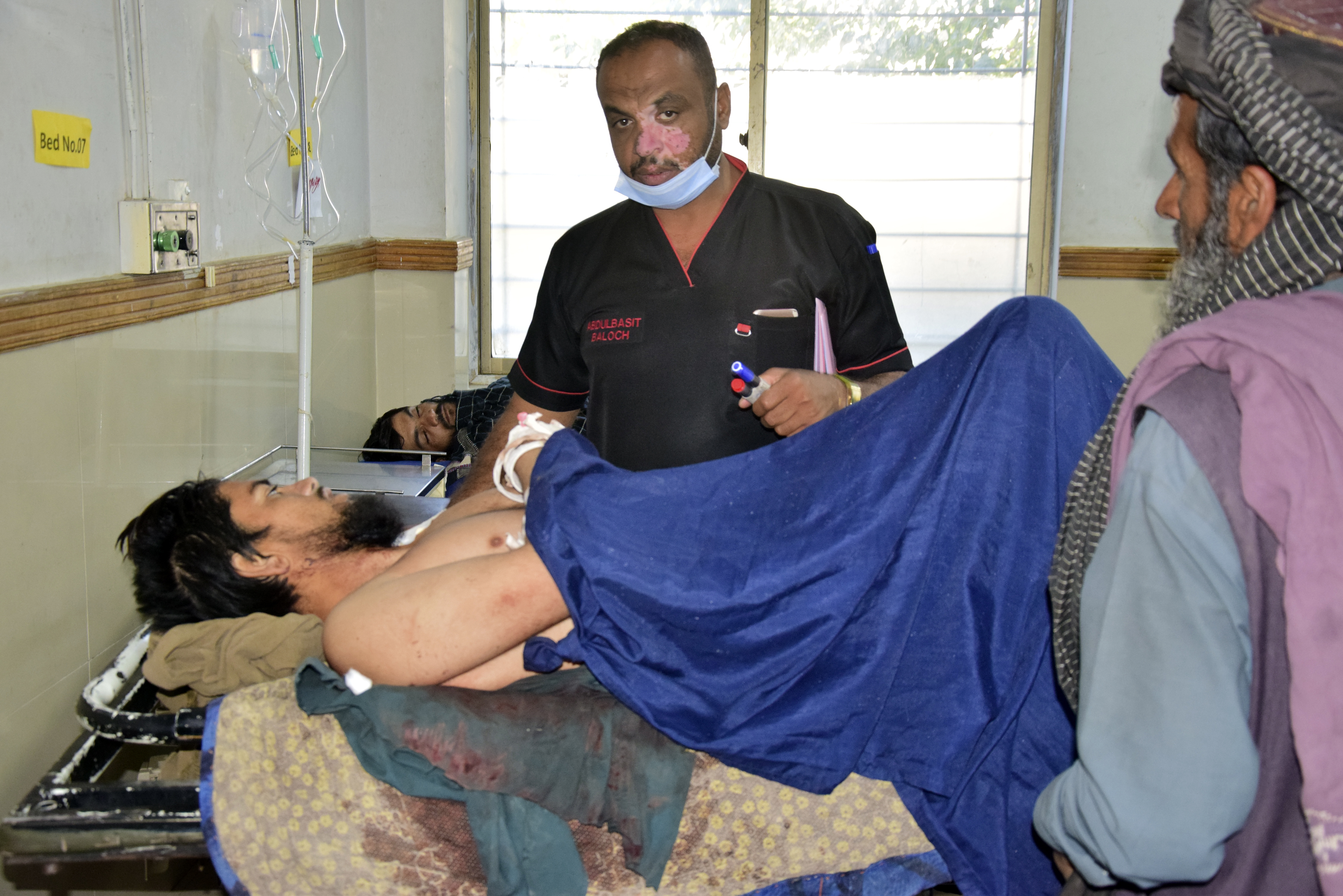 Injured men receive treatment at a hospital in Quetta, Pakistan, Friday, Oct. 11, 2024, following Thursday attack by gunmen in Balochistan province. (AP Photo/Arshad Butt)