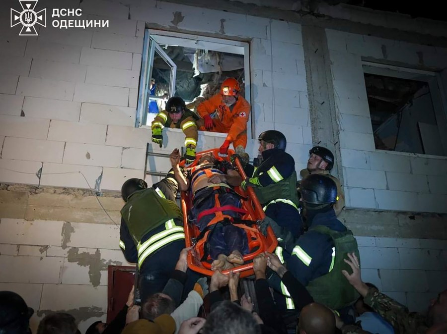 In this photo provided by the Ukrainian Emergency Service, Emergency workers carry a wounded resident after Russian missile attack in Odesa, Ukraine, late Thursday, Oct. 10, 2024. Four Russian missile and drone attacks on the Odesa region this week have killed 14 people and wounded around 20, according to local officials. (Ukrainian Emergency Service via AP)