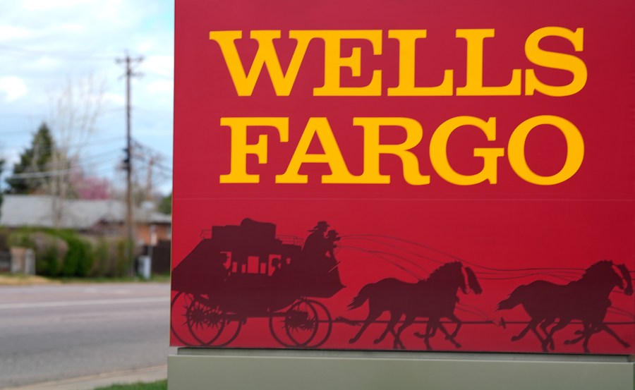 FILE - A sign stands outside a branch of Wells Fargo bank on April 17, 2024, in Littleton, Colo. (AP Photo/David Zalubowski, File)