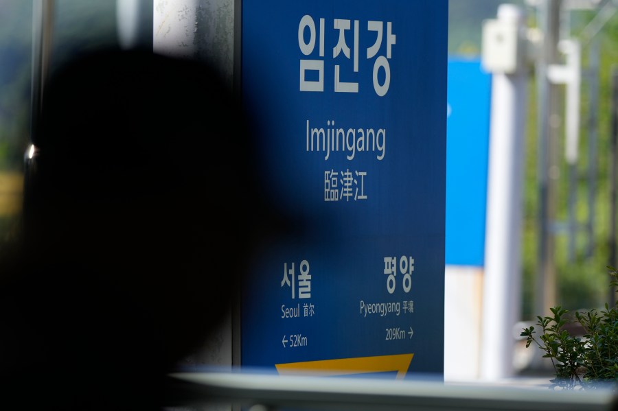 A visitor walks past near a signboard showing the distance to North Korea's capital Pyongyang and to South Korea's capital Seoul from Imjingang Station in Paju, South Korea, Wednesday, Oct. 9, 2024. (AP Photo/Lee Jin-man)