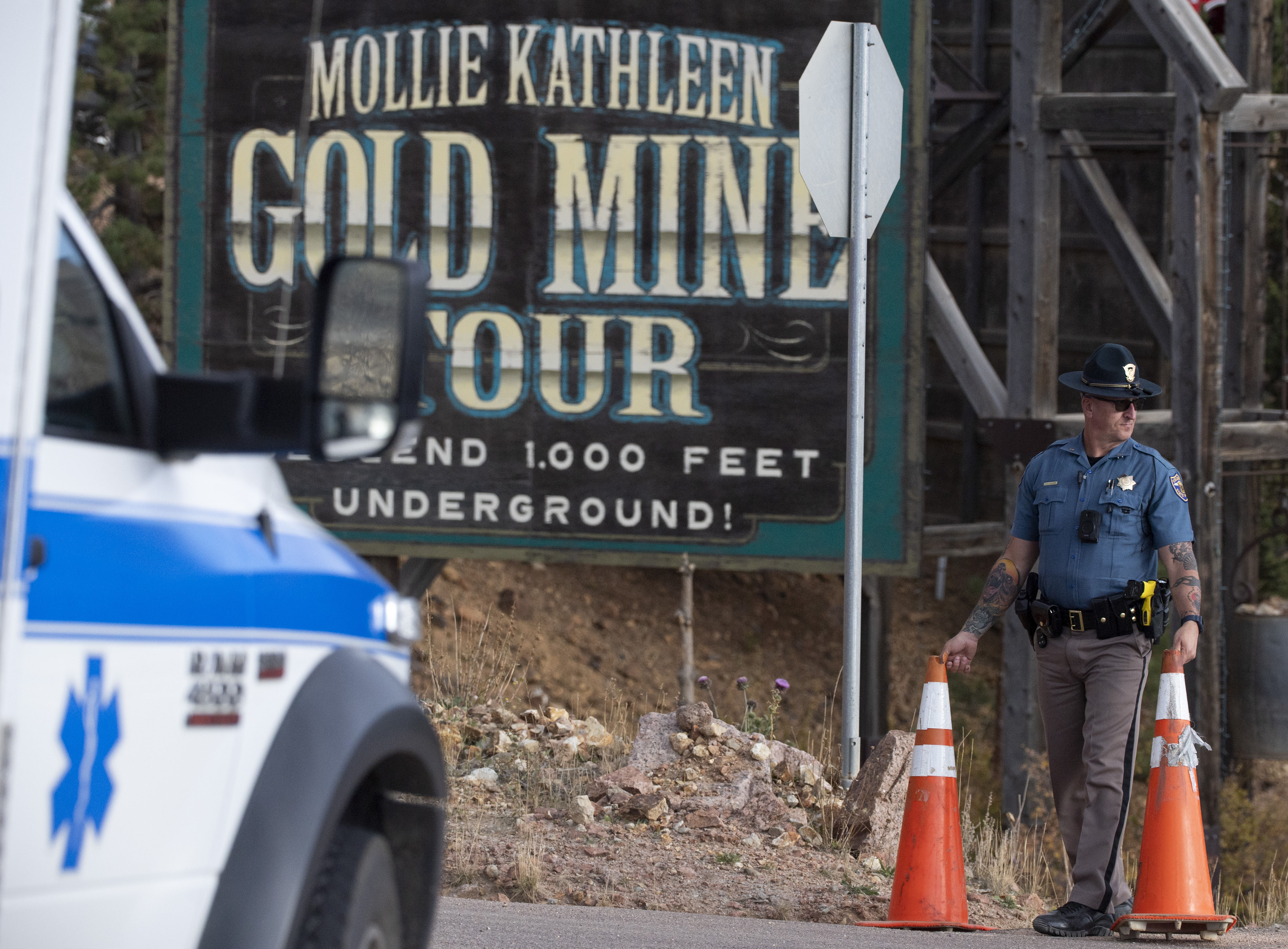 A police officer moves a barrier for an emergency vehicle Thursday, Oct. 9, 2024, at Mollie Kathleen Gold Mine in Cripple Creek, Colo. (Arthur H. Trickett-Wile/The Gazette via AP)