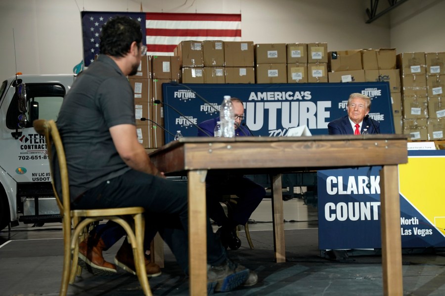 Elias Trujillo, left, speaks as Republican presidential nominee former President Donald Trump, from right, and Goya Foods CEO Robert Unanue listen during a campaign event, Saturday, Oct. 12, 2024, in North Las Vegas, Nev. (AP Photo/Lucas Peltier)