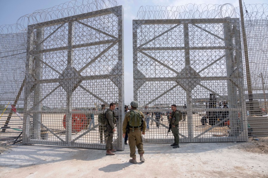 FILE - Israeli soldiers gather near a gate to walks through an inspection area for trucks carrying humanitarian aid supplies bound for the Gaza Strip, on the Israeli side of the Erez crossing into northern Gaza, on May 1, 2024. (AP Photo/Ohad Zwigenberg, File)