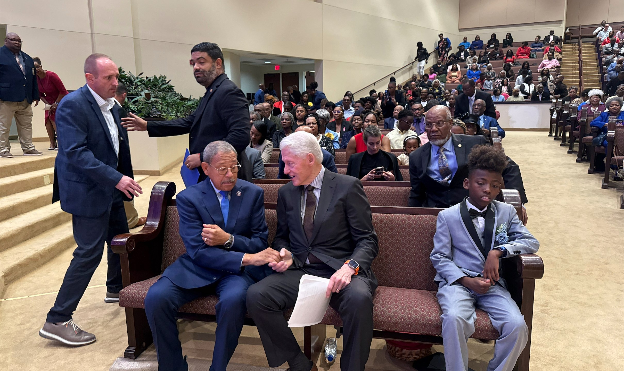 Former President Bill Clinton and US Rep. Sanford Bishop talk while seated at Mt. Zion Baptist Church in Albany, Ga. on Sunday, Oct. 13, 2024. (AP Photo/Charlotte Kramon)