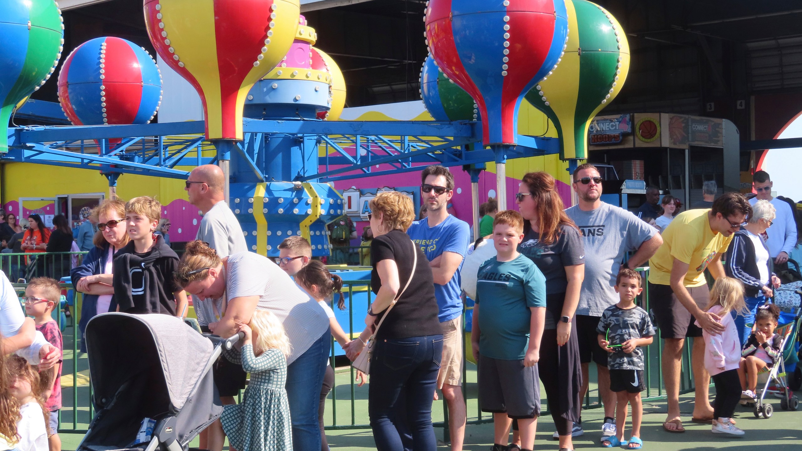 People wait in line to board rides at Gillian's Wonderland, the popular amusement park on the boardwalk in Ocean City, N.J., during its final day of operation before shutting down for good, Sunday, Oct. 13, 2024. (AP Photo/Wayne Parry)