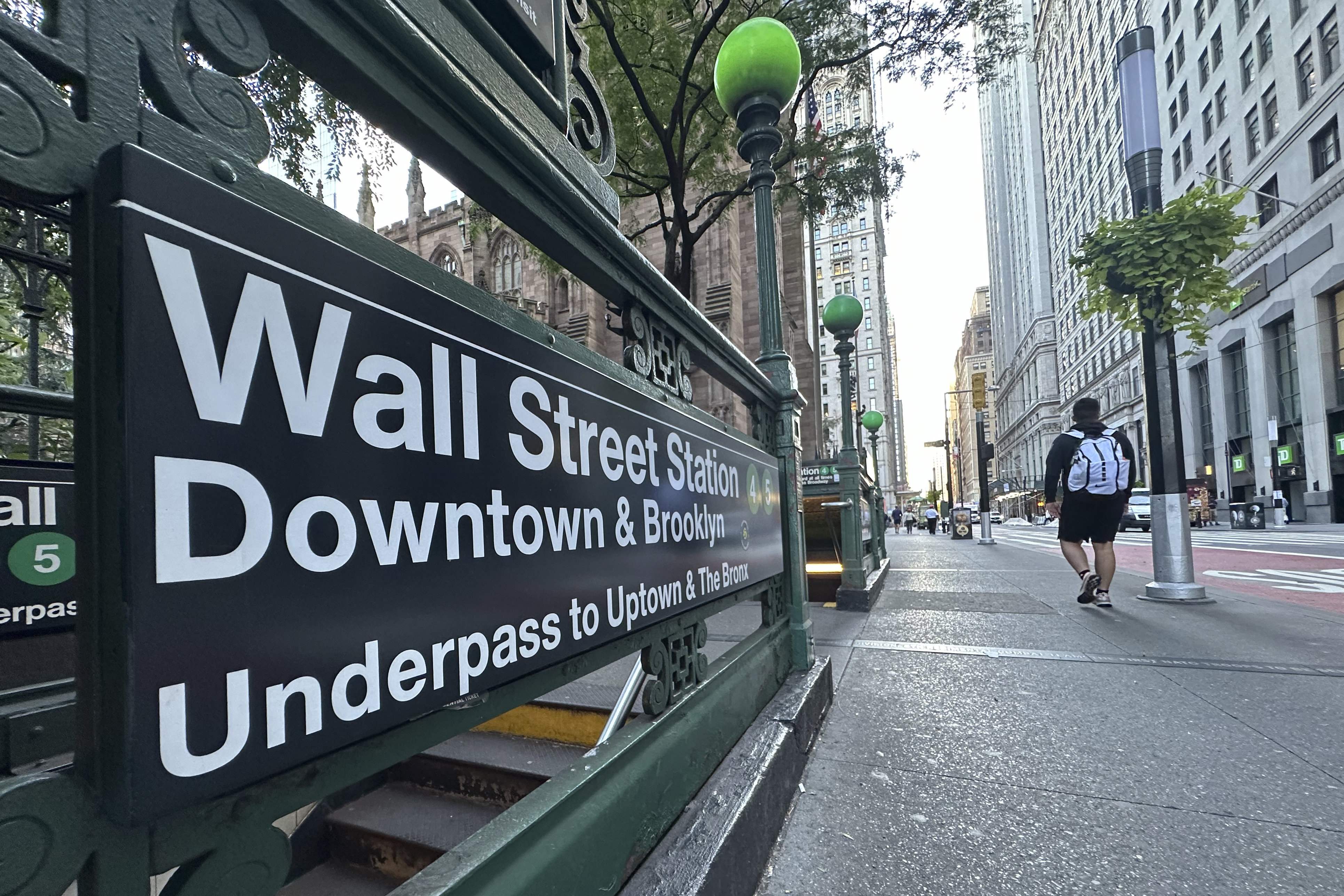 FILE - People pass the entrance for the Wall Street subway station on Sept. 2, 2024, in New York. (AP Photo/Peter Morgan, File)