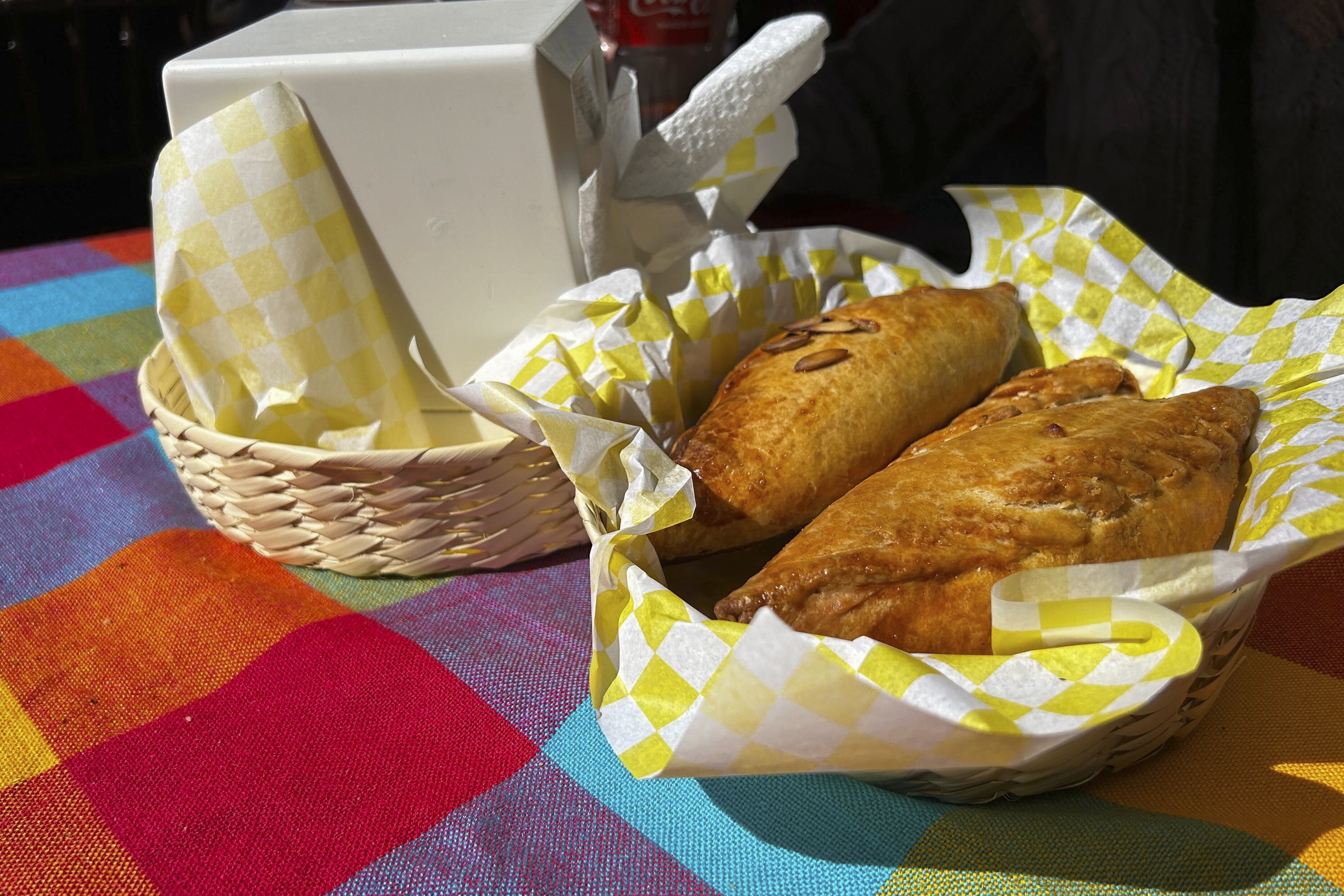 A basket of Mexican pastes sit on a patron's table before they are eated for lunch at the 16th International Paste Festival in Mineral del Monte, Mexico, Saturday, Oct. 12, 2024. (AP Photo/India Grant)