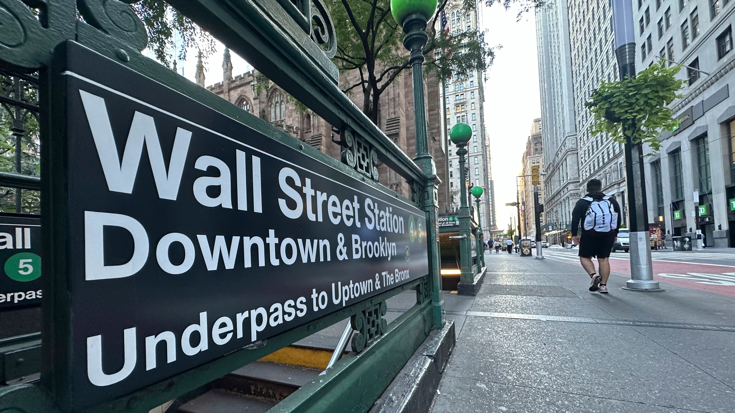 FILE - People pass the entrance for the Wall Street subway station on Sept. 2, 2024, in New York. (AP Photo/Peter Morgan, File)