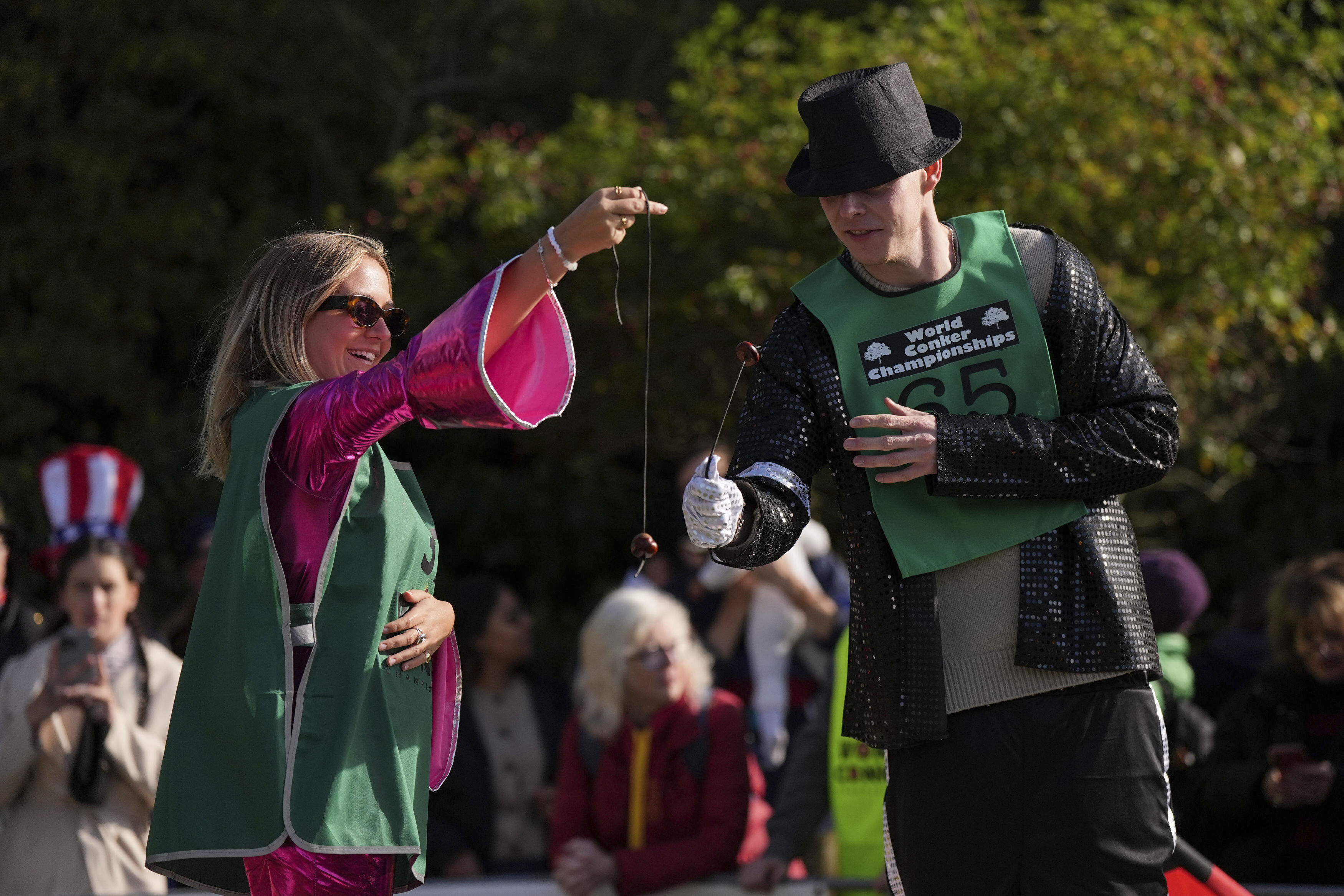 Competitors take part in the annual World Conker Championships at the Shuckburgh Arms in Southwick, Peterborough, England, Sunday Oct. 13, 2024. (Jacob King/PA via AP)