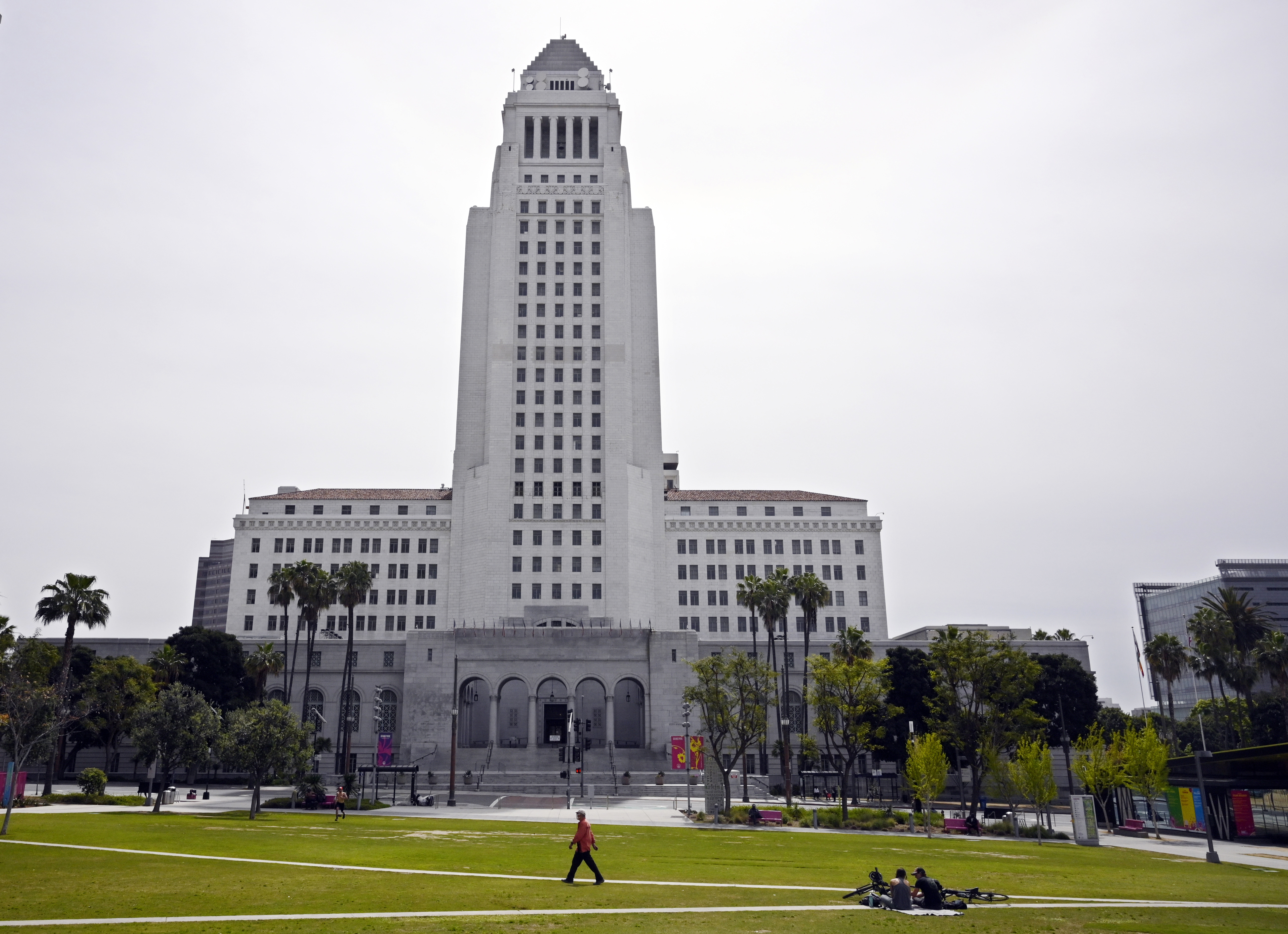 FILE - A few people use Grand Park at the foot of Los Angeles City Hall, Tuesday, March 31, 2020, in Los Angeles. (AP Photo/Mark J. Terrill, File)