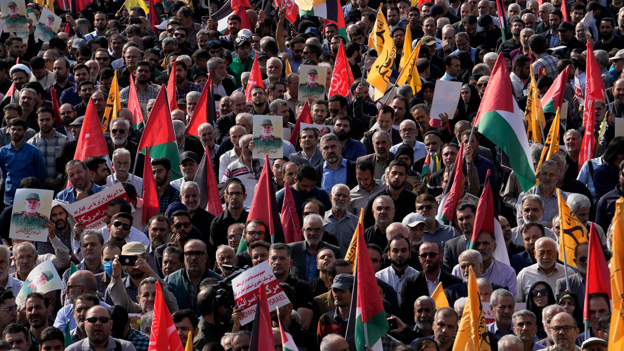 People attend the funeral ceremony of the late Iranian Revolutionary Guard Gen. Abbas Nilforushan, who was killed in an Israeli airstrike in Beirut in late September, in Tehran, Iran, Tuesday, Oct. 15, 2024. (AP Photo/Vahid Salemi)