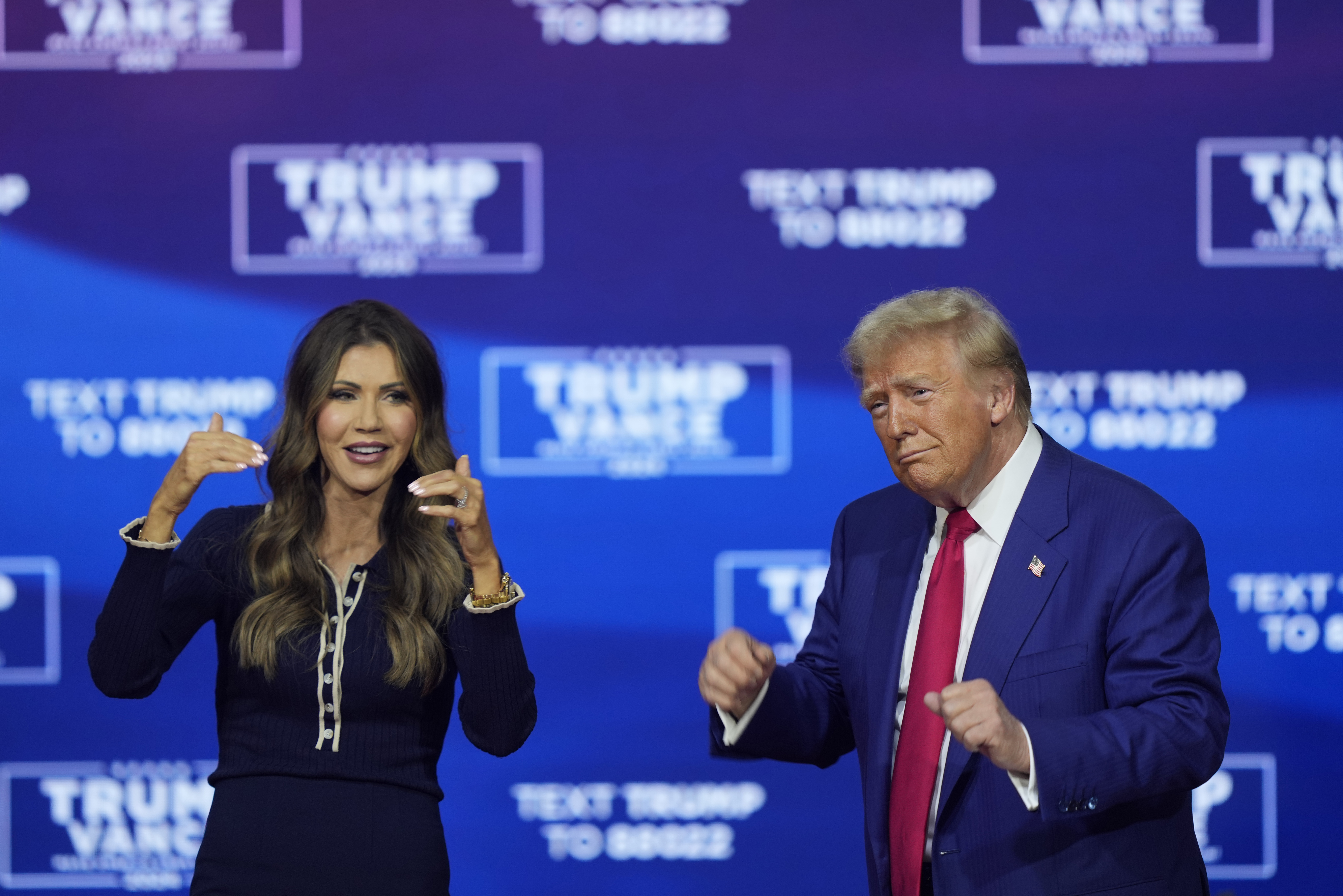 Republican presidential nominee former President Donald Trump and South Dakota Gov. Kristi Noem dance to the song "Y.M.C.A." at a campaign town hall at the Greater Philadelphia Expo Center & Fairgrounds, Monday, Oct. 14, 2024, in Oaks, Pa. (AP Photo/Matt Rourke)