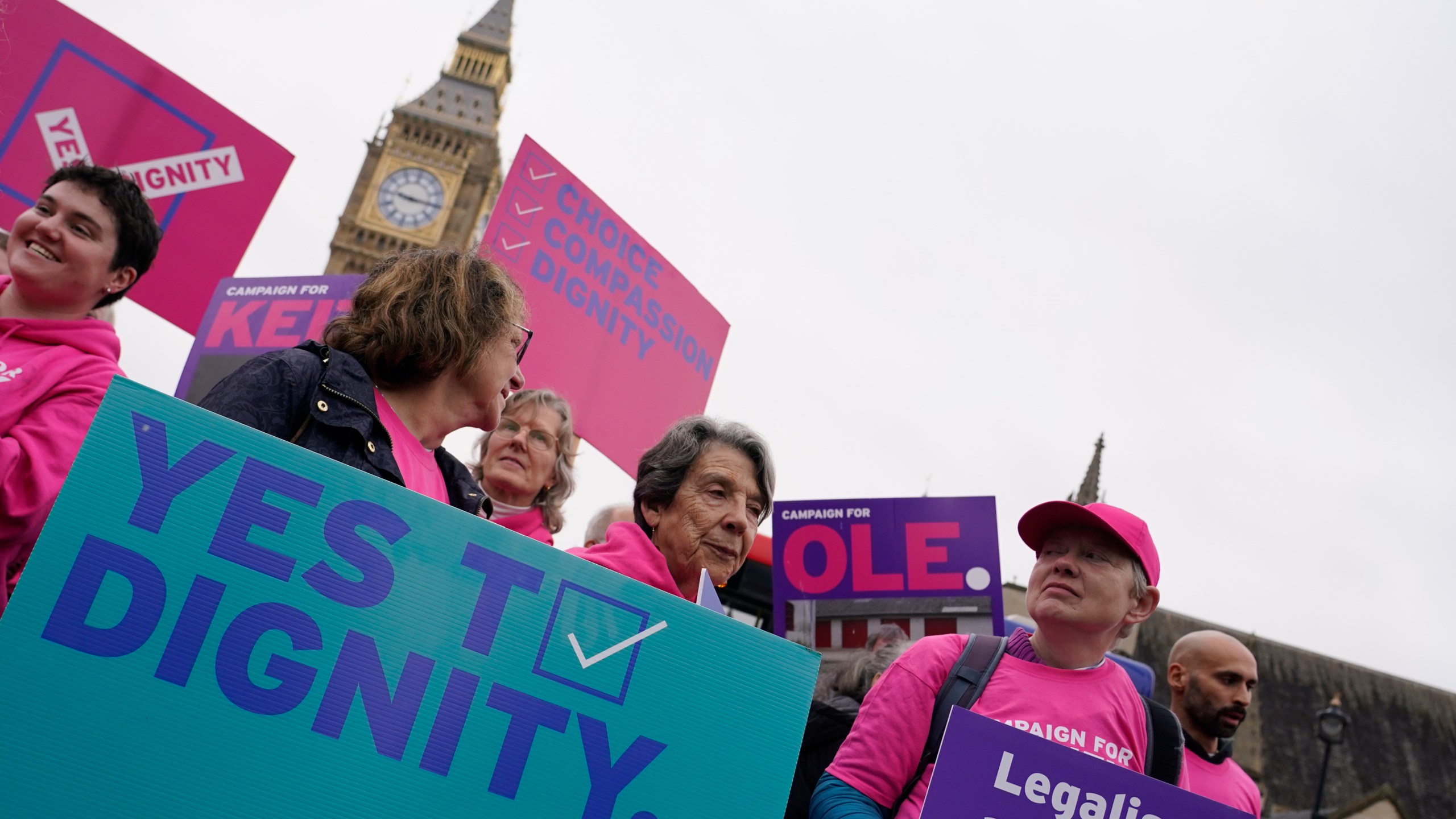 A small demonstration by people advocating assisted dying hold a protest outside the Hoses of Parliament as a bill to legalise assisted dying is to be put before lawmakers in London, England, Wednesday, Oct. 16, 2024. (AP Photo/Alberto Pezzali)