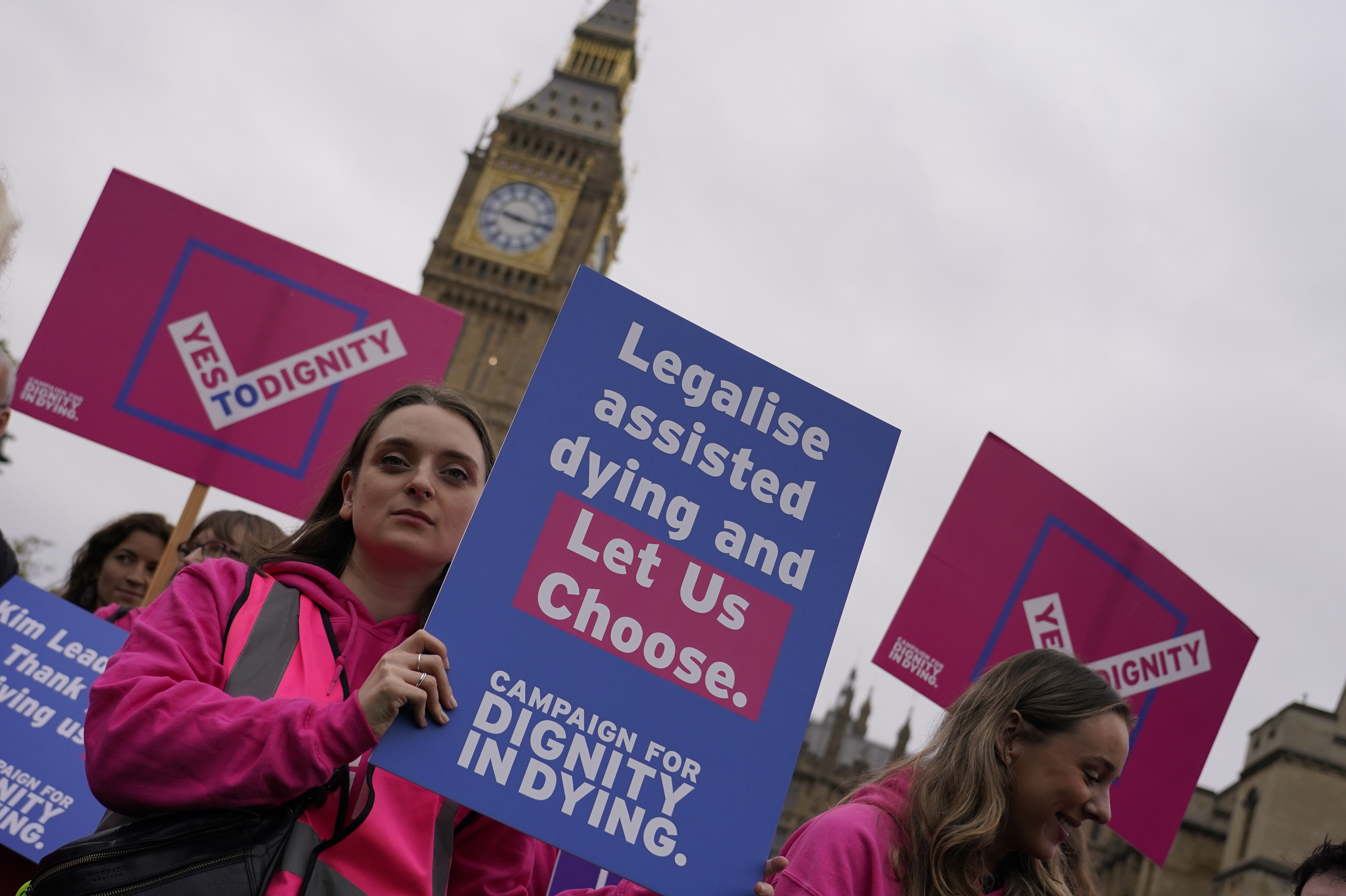 A small demonstration by people advocating assisted dying hold a protest outside the Hoses of Parliament as a bill to legalise assisted dying is to be put before lawmakers in London, England, Wednesday, Oct. 16, 2024. (AP Photo/Alberto Pezzali)