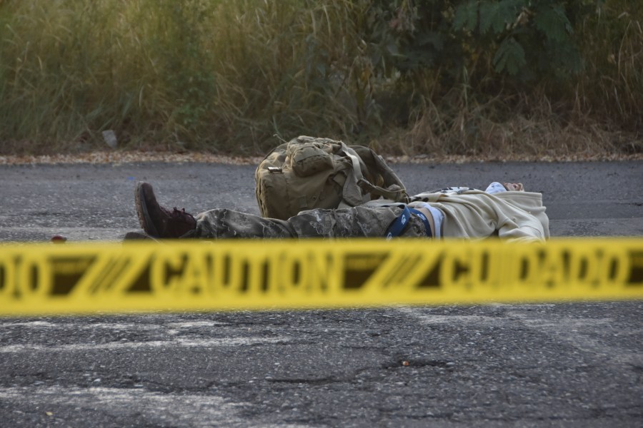 Caution tape surrounds a body lying on the street Culiacan, Sinaloa state, Mexico, Monday, Oct. 14, 2024. (AP Photo)