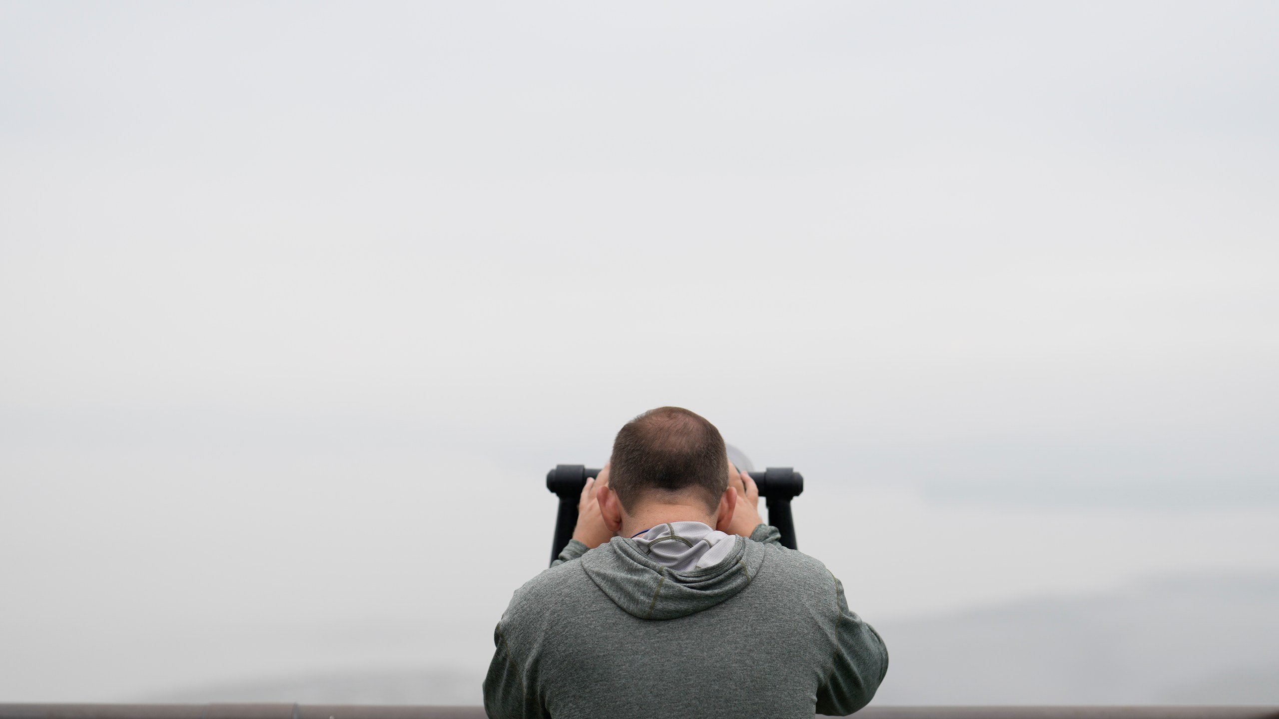 A visitor uses binoculars to see the North Korean side from the unification observatory in Paju, South Korea, Tuesday, Oct. 15, 2024. (AP Photo/Lee Jin-man)