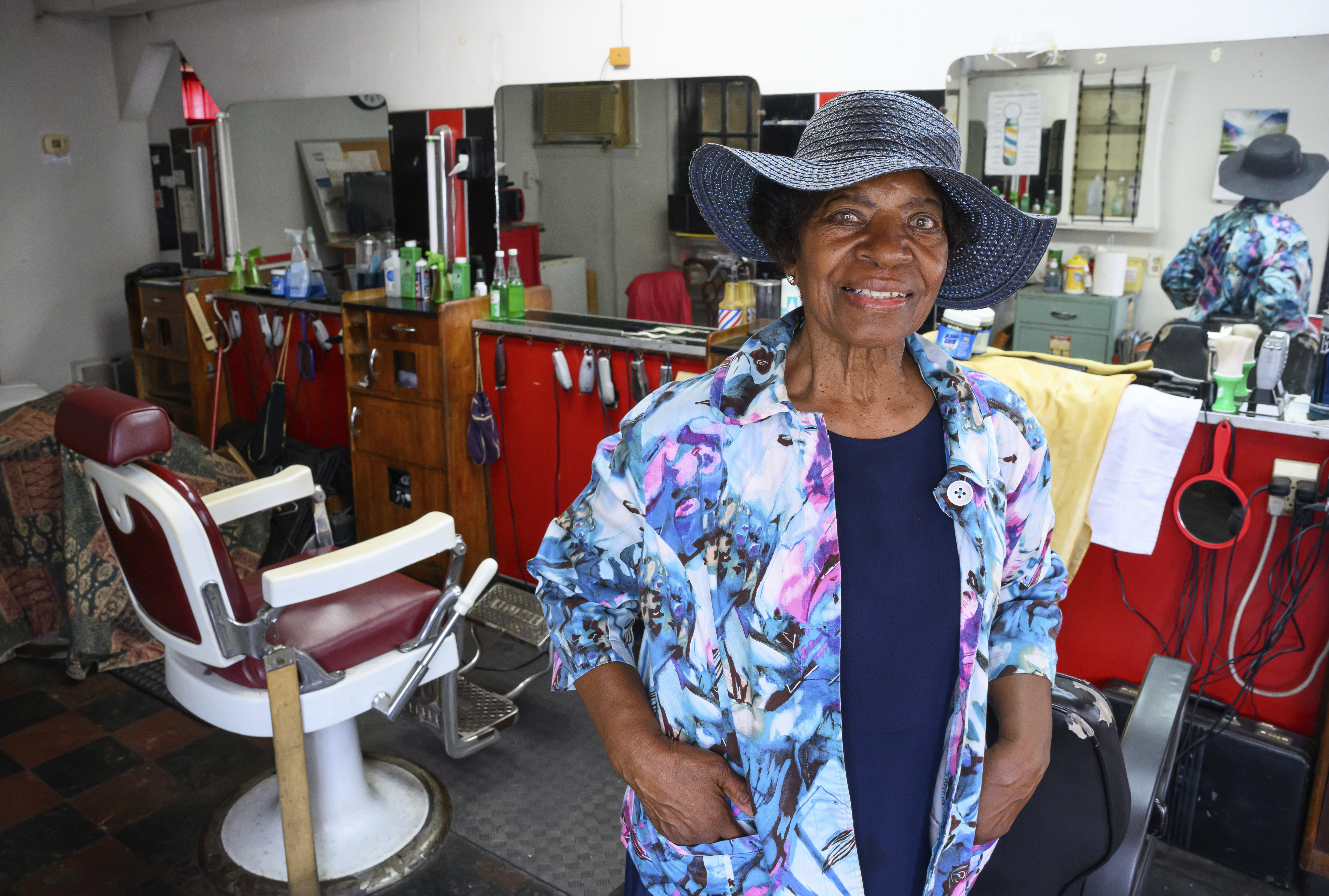 Courtney Speed, of Turner Station, Md., stands in Speed's Barber and Beauty, her salon, Sunday, Aug. 18, 2024, in Turner Station. Turner Station is located near the former site of the Francis Scott Key Bridge, which collapsed in March. (AP Photo/Steve Ruark)