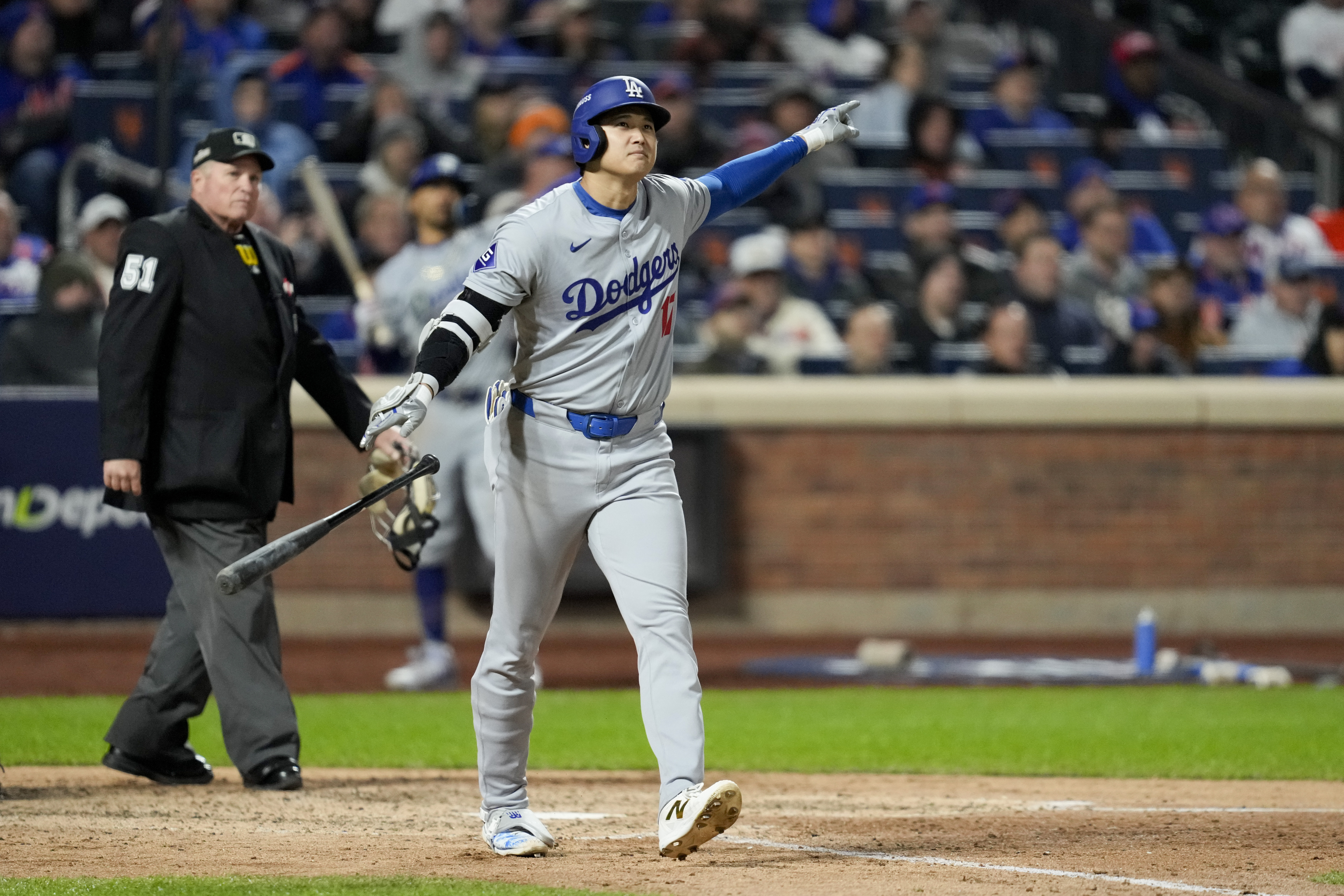 Los Angeles Dodgers' Shohei Ohtani celebrates his three-run home run against the New York Mets during the eighth inning in Game 3 of a baseball NL Championship Series, Wednesday, Oct. 16, 2024, in New York. (AP Photo/Ashley Landis)