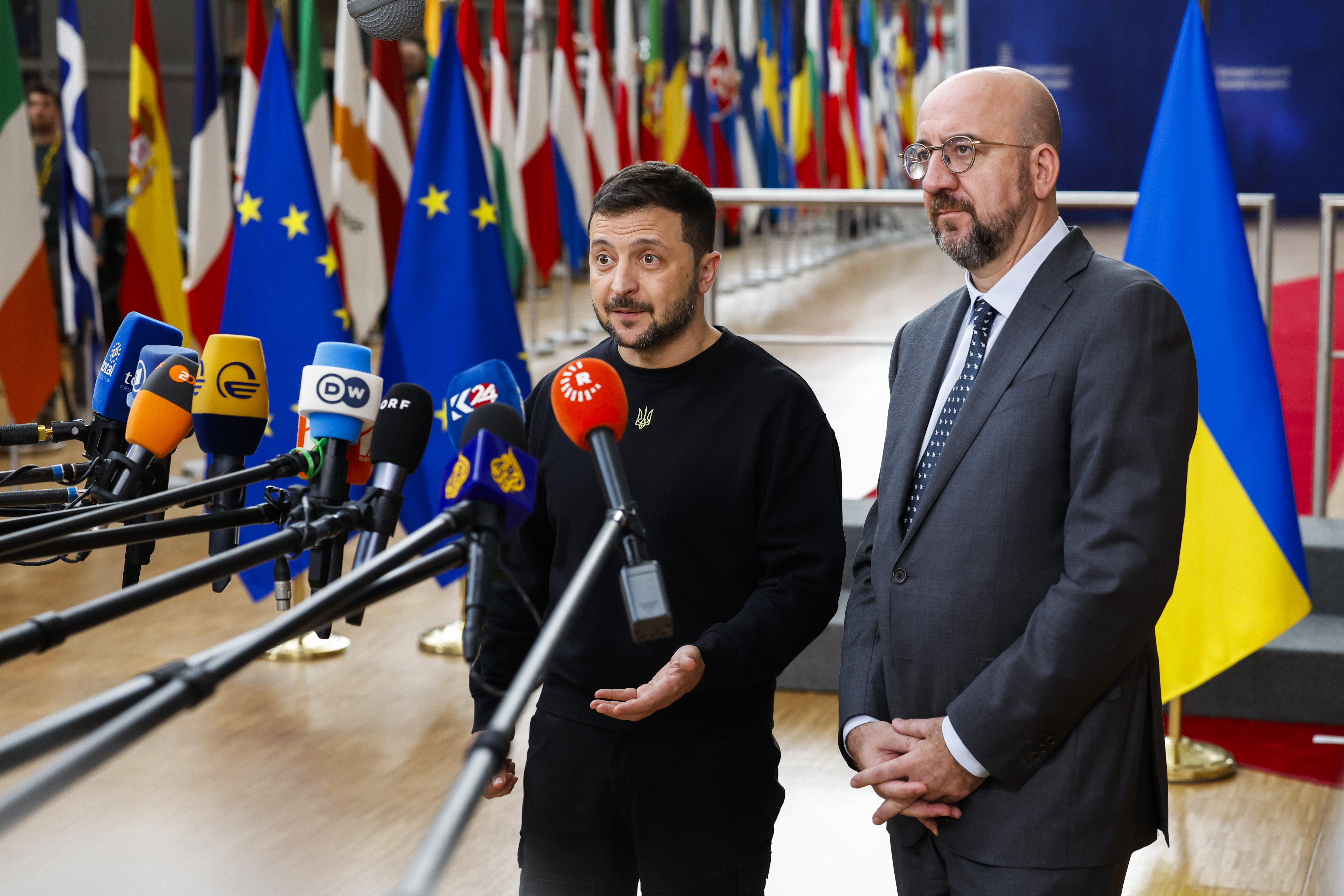 Ukraine's President Volodymyr Zelenskyy, left, and European Council President Charles Michel talk to journalists as they arrive to an EU summit in Brussels, Thursday, Oct. 17, 2024. (AP Photo/Geert Vanden Wijngaert)