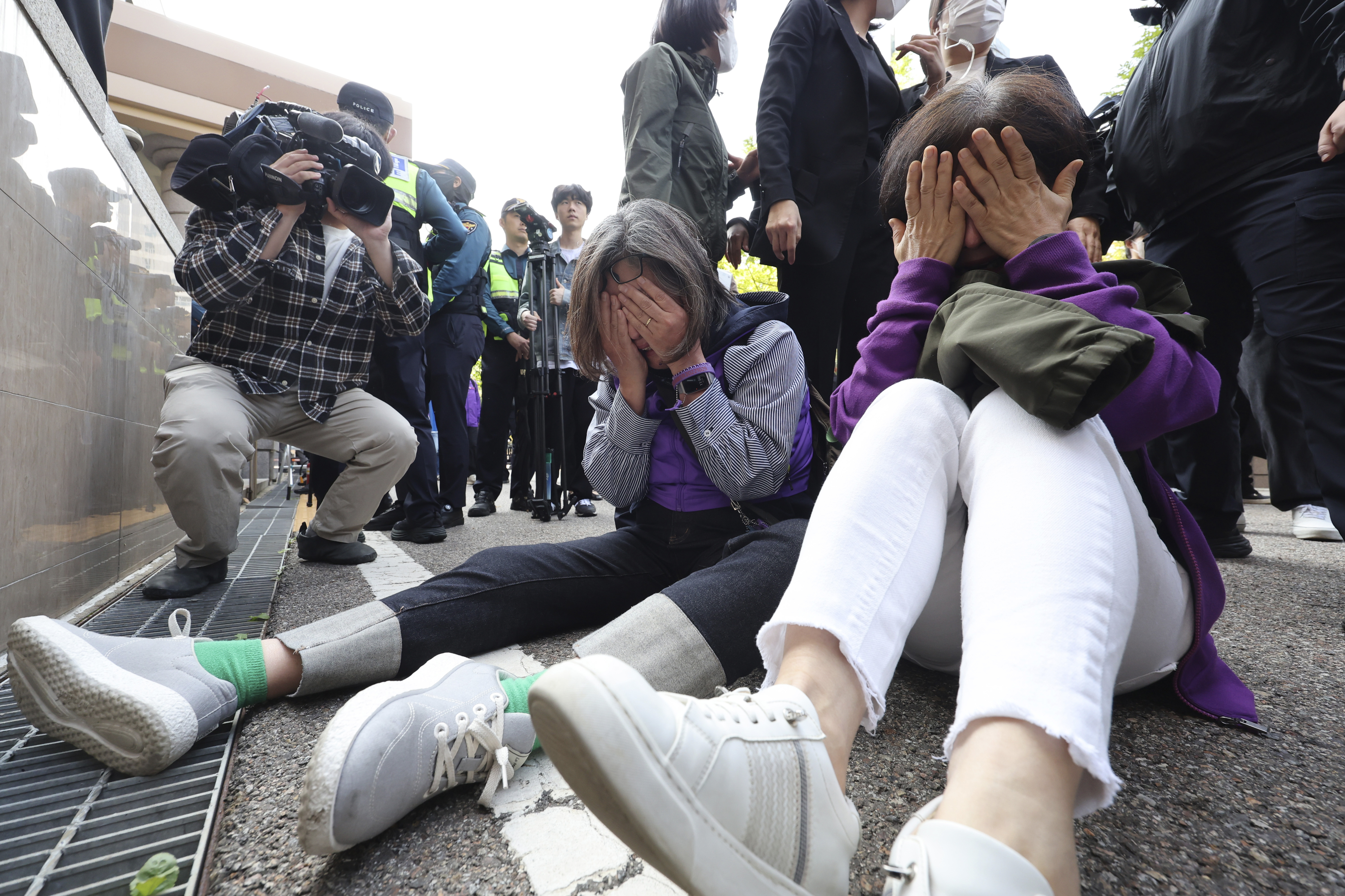 Bereaved family members of the victims of the Halloween crush in 2022 react at the Seoul Western District Court in Seoul, South Korea, Thursday, Oct. 17, 2024. (Lim Hwa-young/Yonhap via AP)