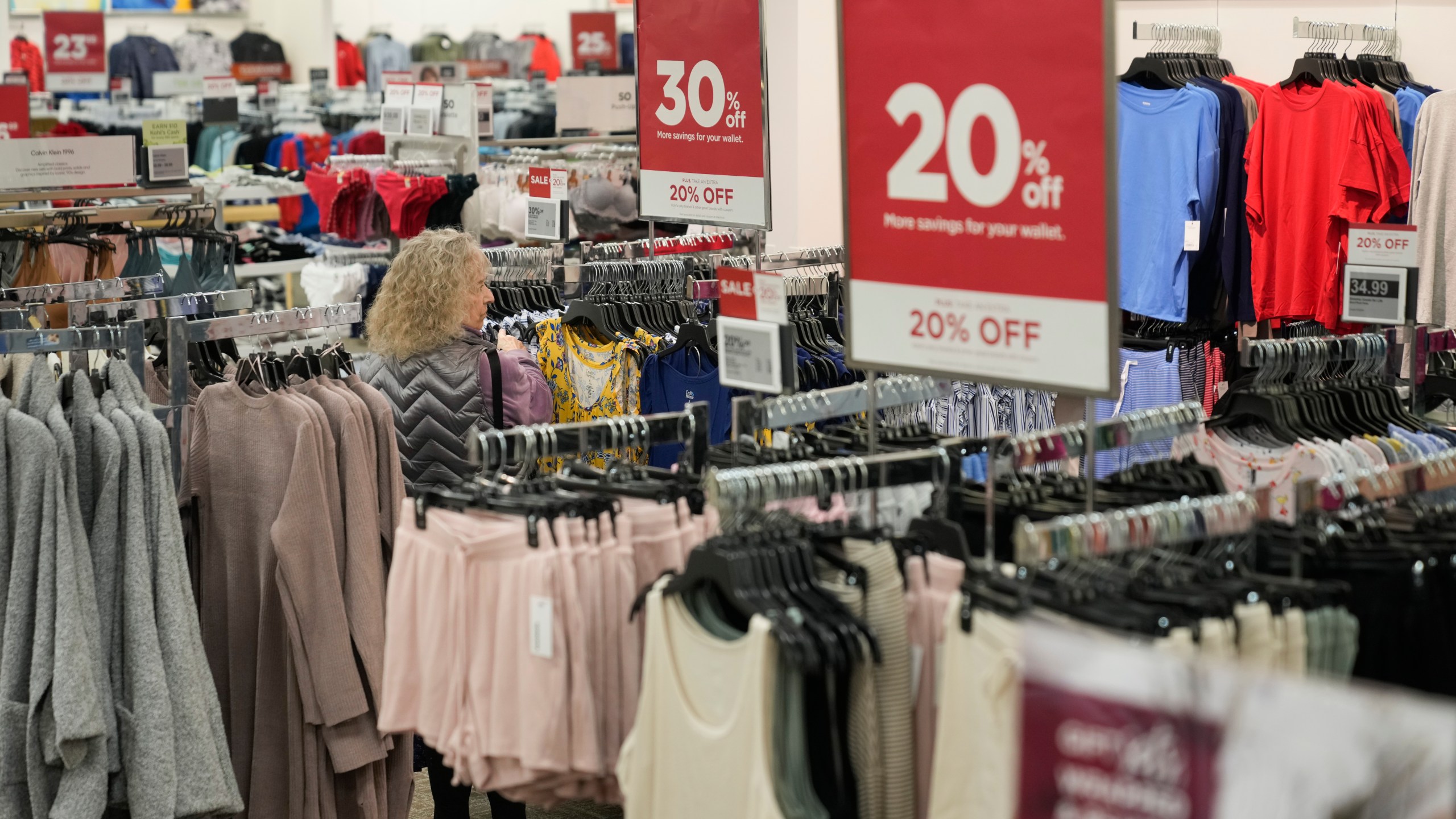 A shopper looks at clothes at a Kohl's in Ramsey, N.J., Thursday, Oct. 10, 2024. (AP Photo/Seth Wenig)