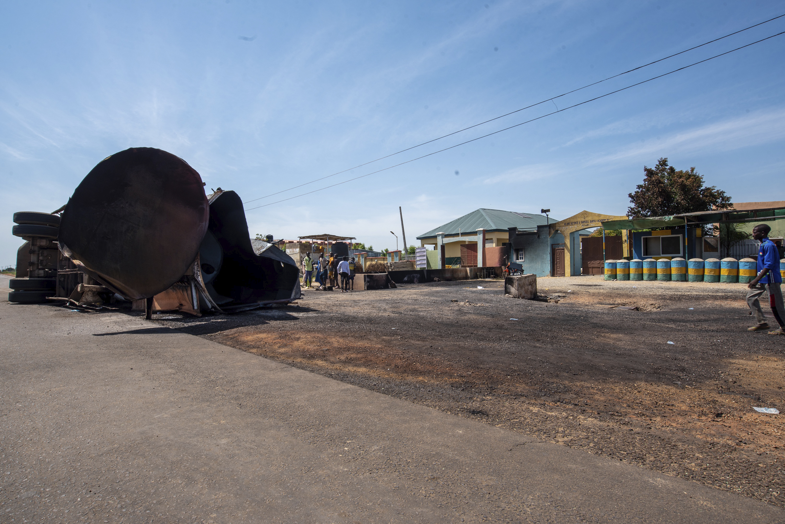 People gather at the scene of a fuel tanker explosion in Majiya town, Nigeria, Wednesday, Oct. 16, 2024. (AP Photo/Sani Maikatanga)