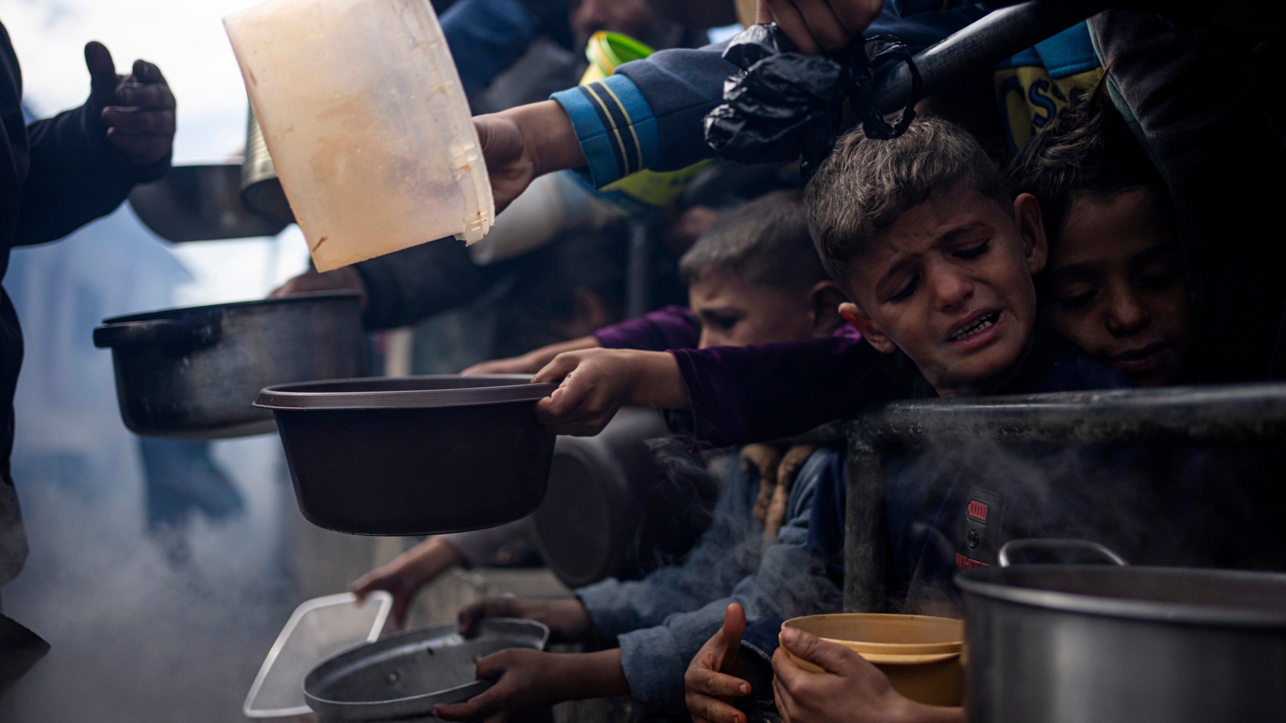 FILE - Palestinians line up for a meal in Rafah, Gaza Strip, Friday, Feb. 16, 2024. (AP Photo/Fatima Shbair, File)