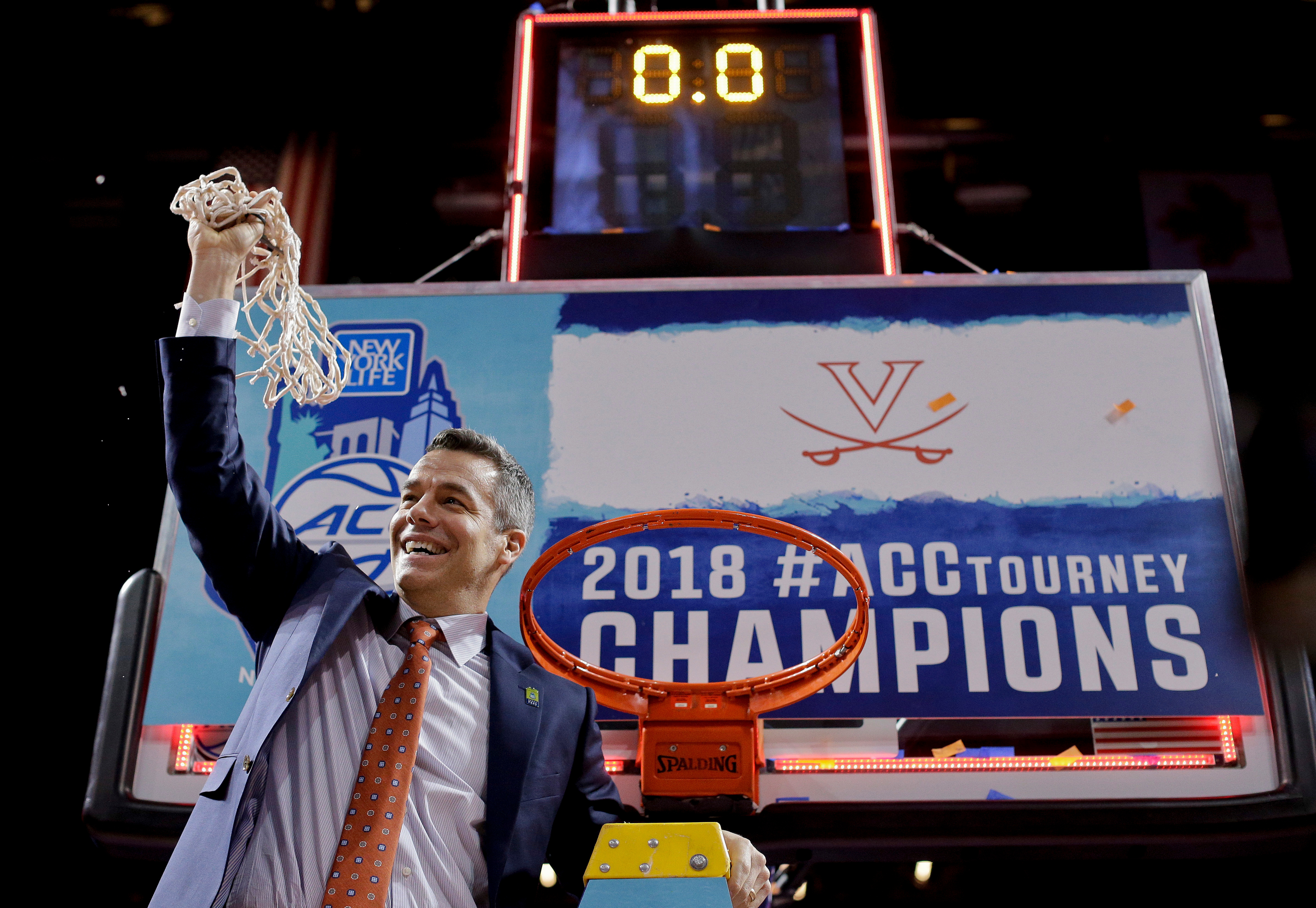 FILE - Virginia head coach Tony Bennett holds up the net after defeating North Carolina in the championship game of the NCAA Atlantic Coast Conference men's college basketball tournament in New York, March 10, 2018. (AP Photo/Julie Jacobson, File)