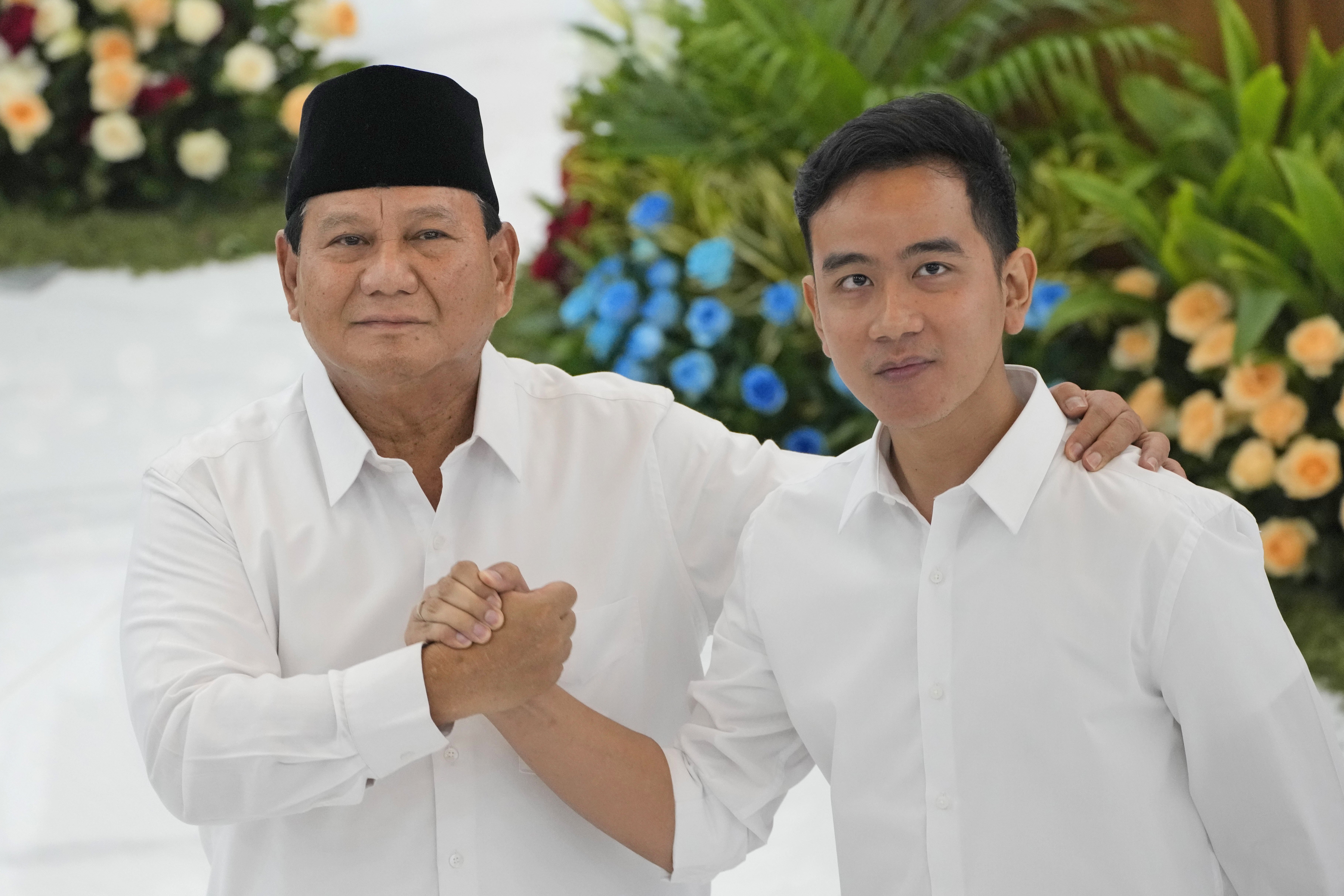 FILE - Indonesian Defense Minister and president-elect Prabowo Subianto, left, shakes hands with his running mate Gibran Rakabuming Raka, the eldest son of Indonesian President JokoWidodo, during their formal declaration as president and vice president-elect at the General Election Commission building in Jakarta, Indonesia, Wednesday, April 24, 2024. (AP Photo/Dita Alangkara, File)