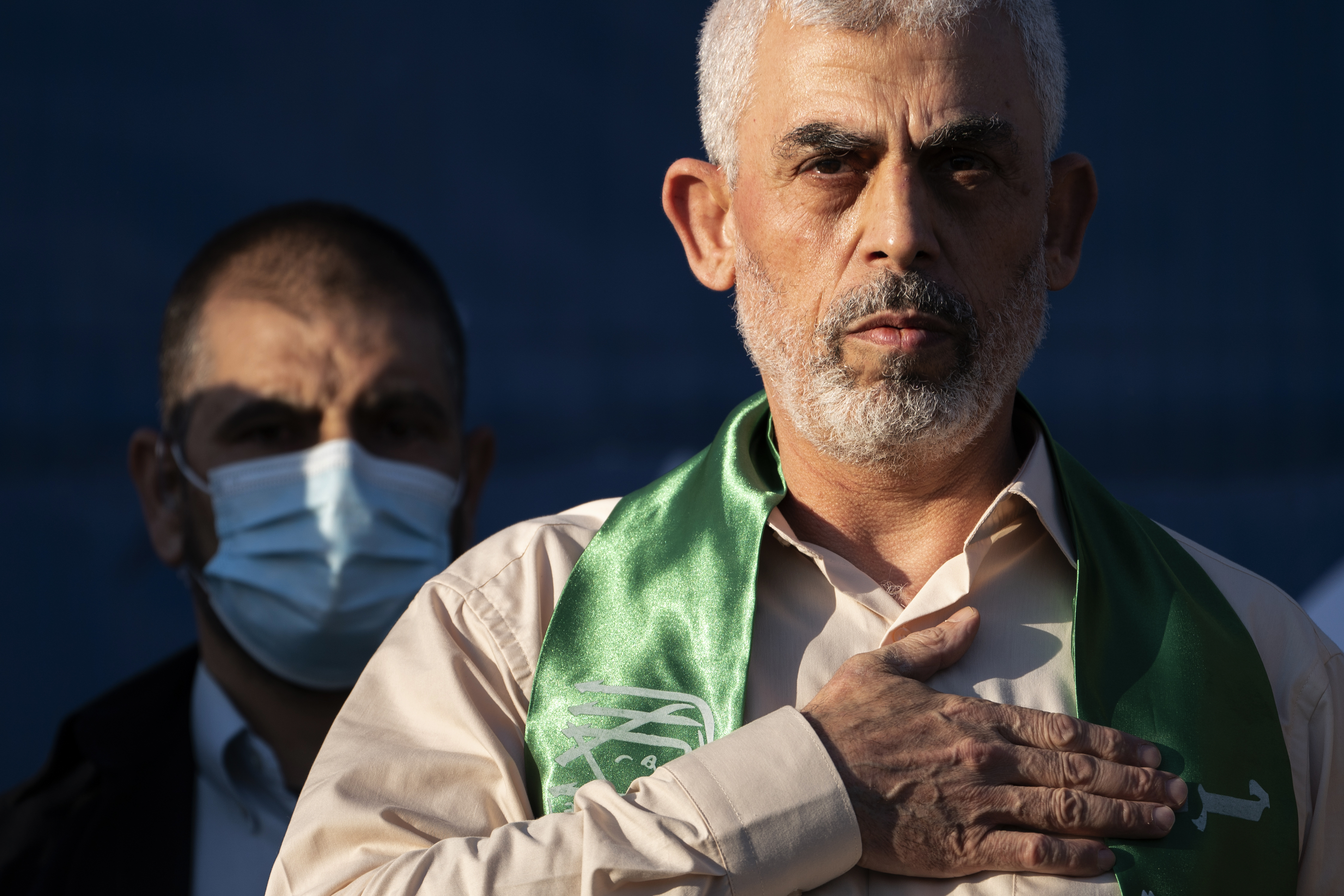 FILE - Yahya Sinwar, Palestinian leader of Hamas in the Gaza Strip, places his hand over his heart on stage after greeting supporters at a rally on May 24, 2021, in Gaza City, the Gaza Strip. (AP Photo/John Minchillo, File)